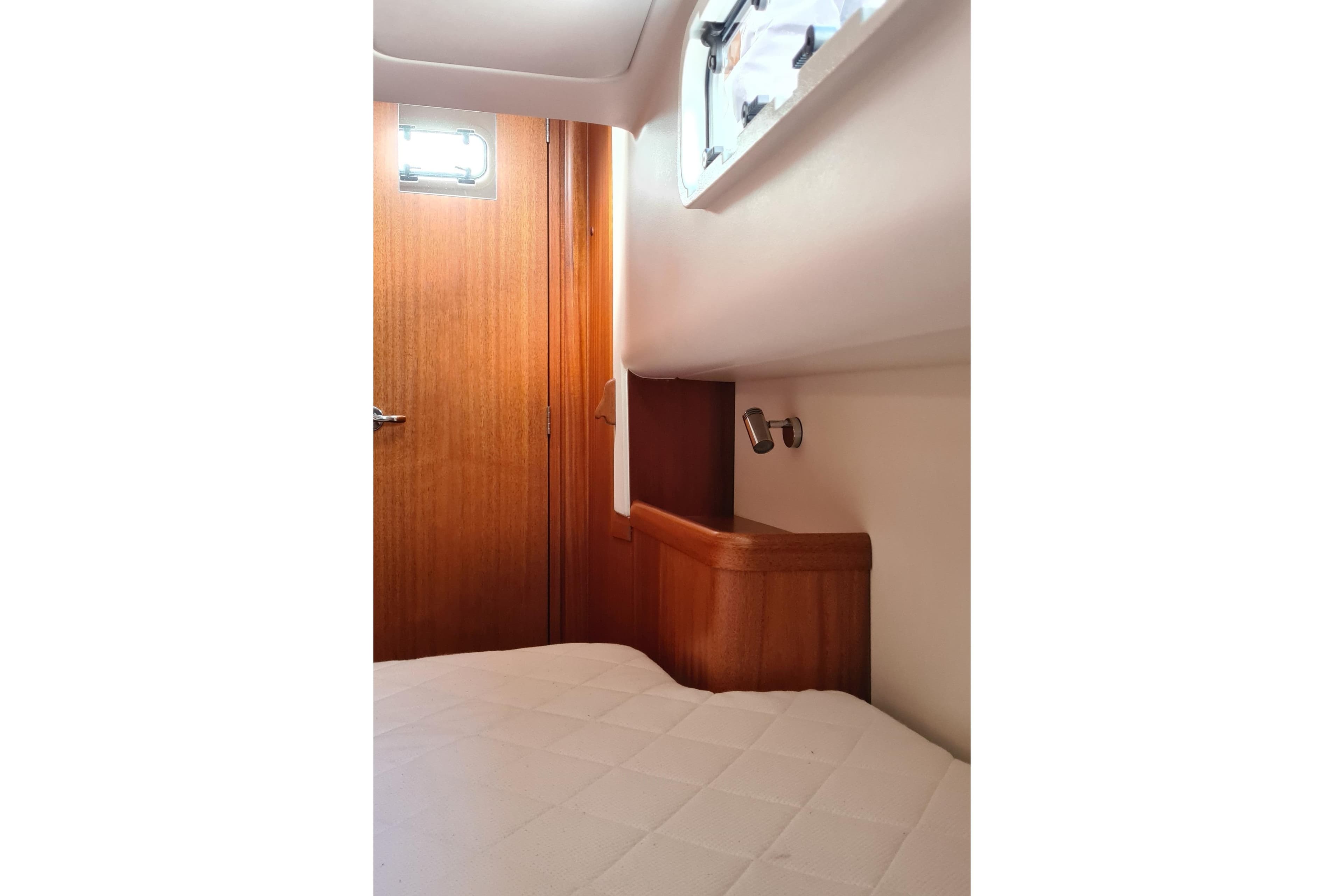 Interior cabin of 2018 Arcona 435 yacht with wooden door and window.