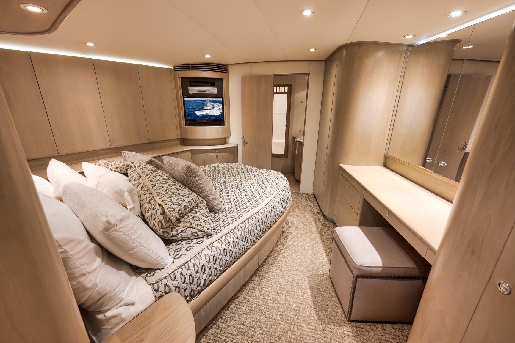 Luxurious cabin interior of 1993 Merritt Sportfish yacht with elegant bedding and modern design.