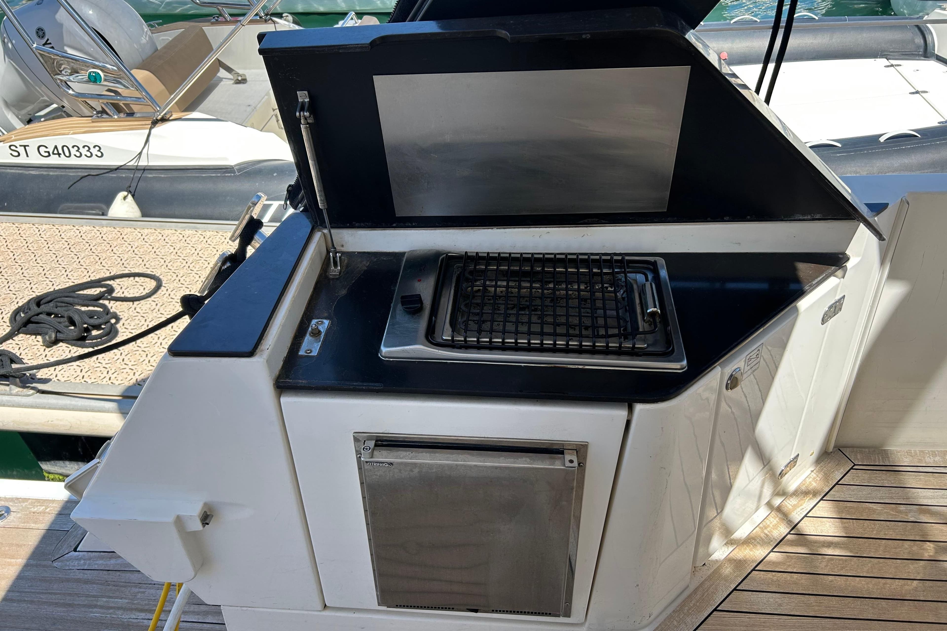 Outdoor grill on 2012 Sealine F42 yacht deck, featuring stainless steel finish.