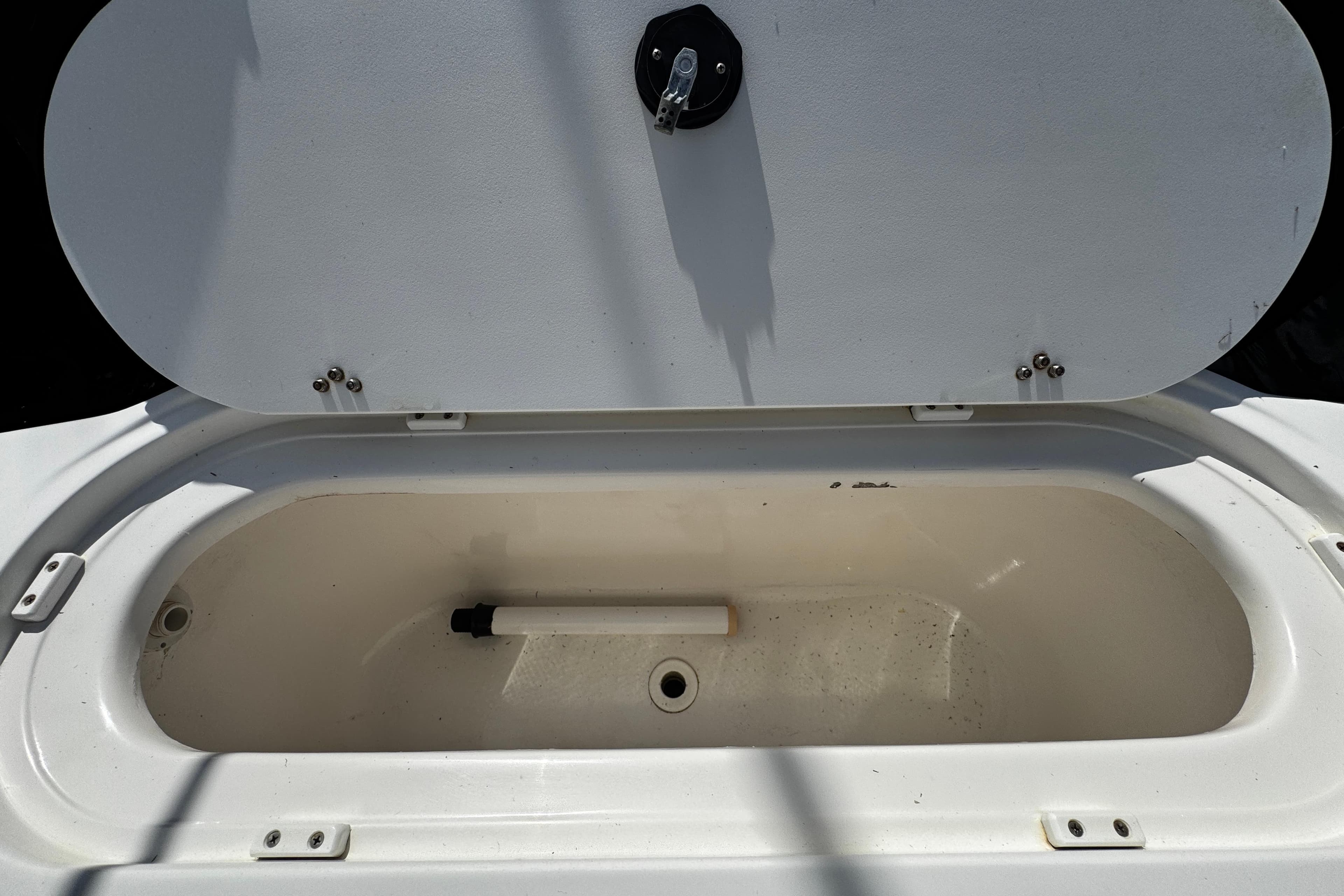 Open storage compartment on a 2004 Dusky 33 boat, featuring a clean interior.