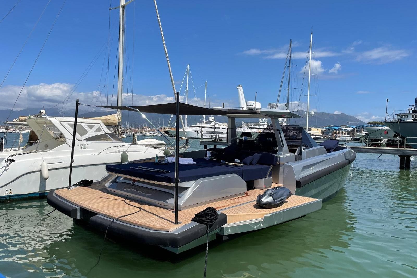2019 Wally wallytender48 yacht docked in a marina under a clear blue sky.