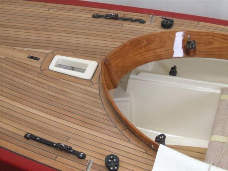 2025 Rustler 24 sailboat deck with polished wood finish and sleek design.