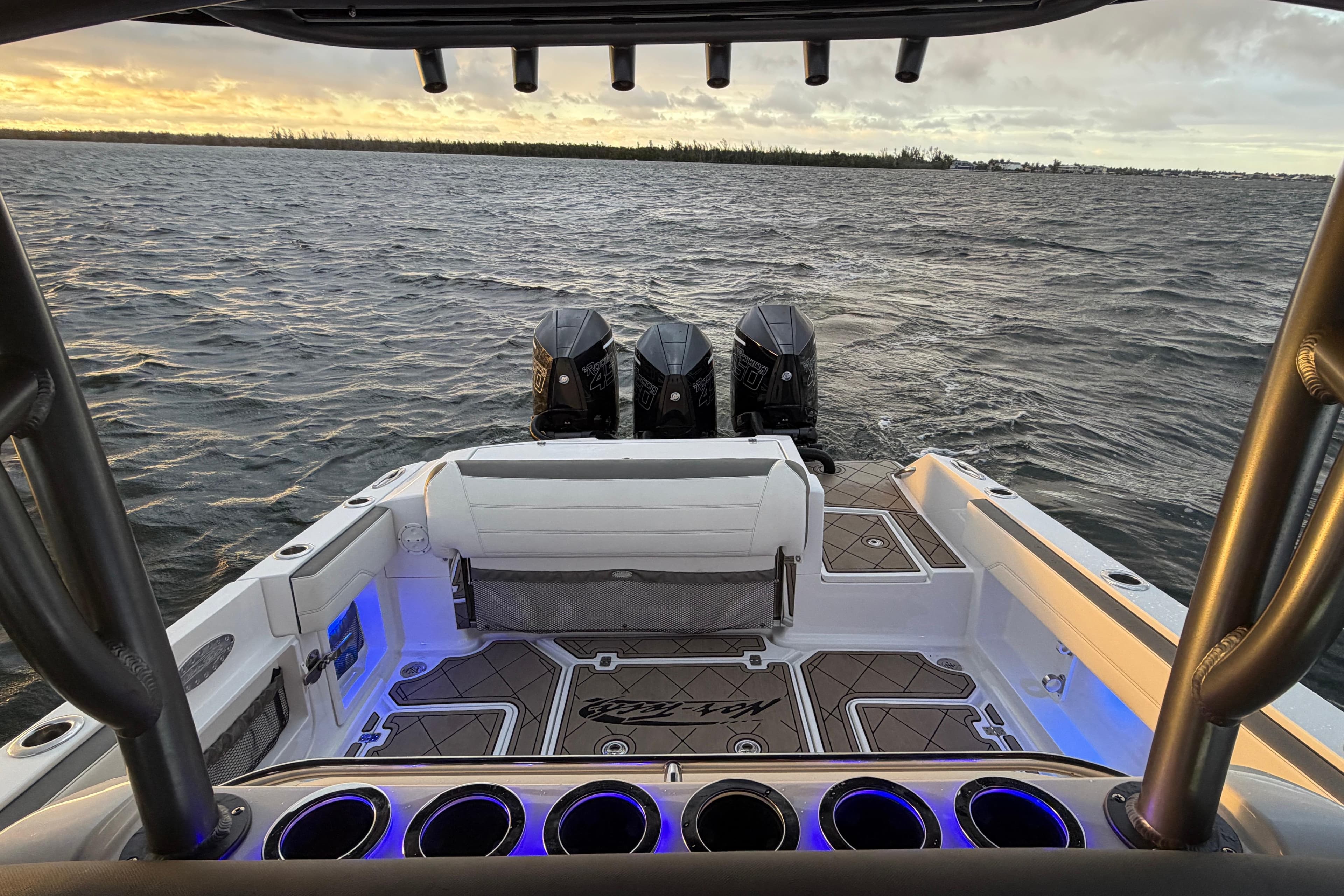 2021 Nor-Tech 390 Sport Center Console boat with triple engines on open water.
