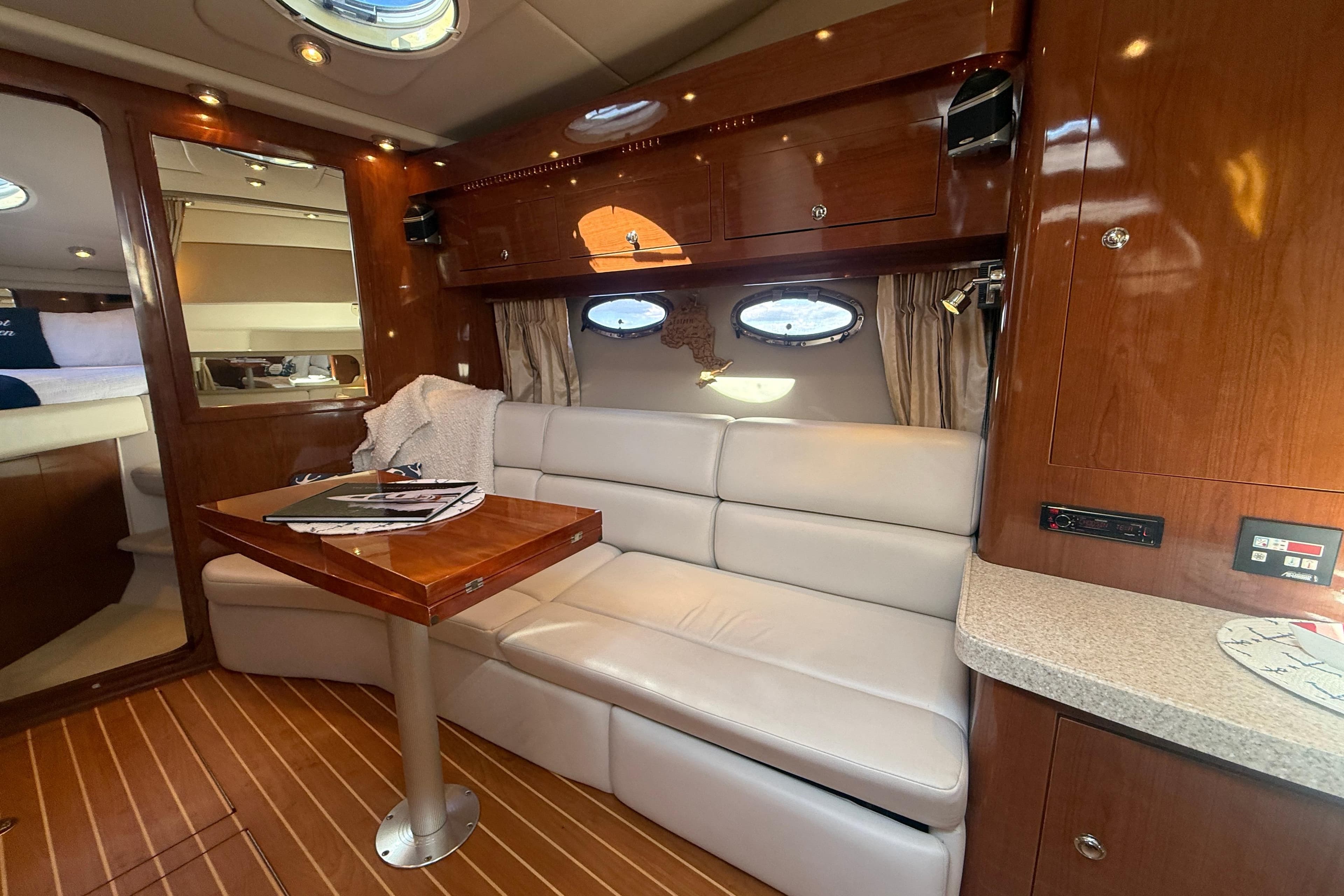 Luxurious interior of 2006 Regal Commodore 3560 IO yacht with leather seating and wooden accents.