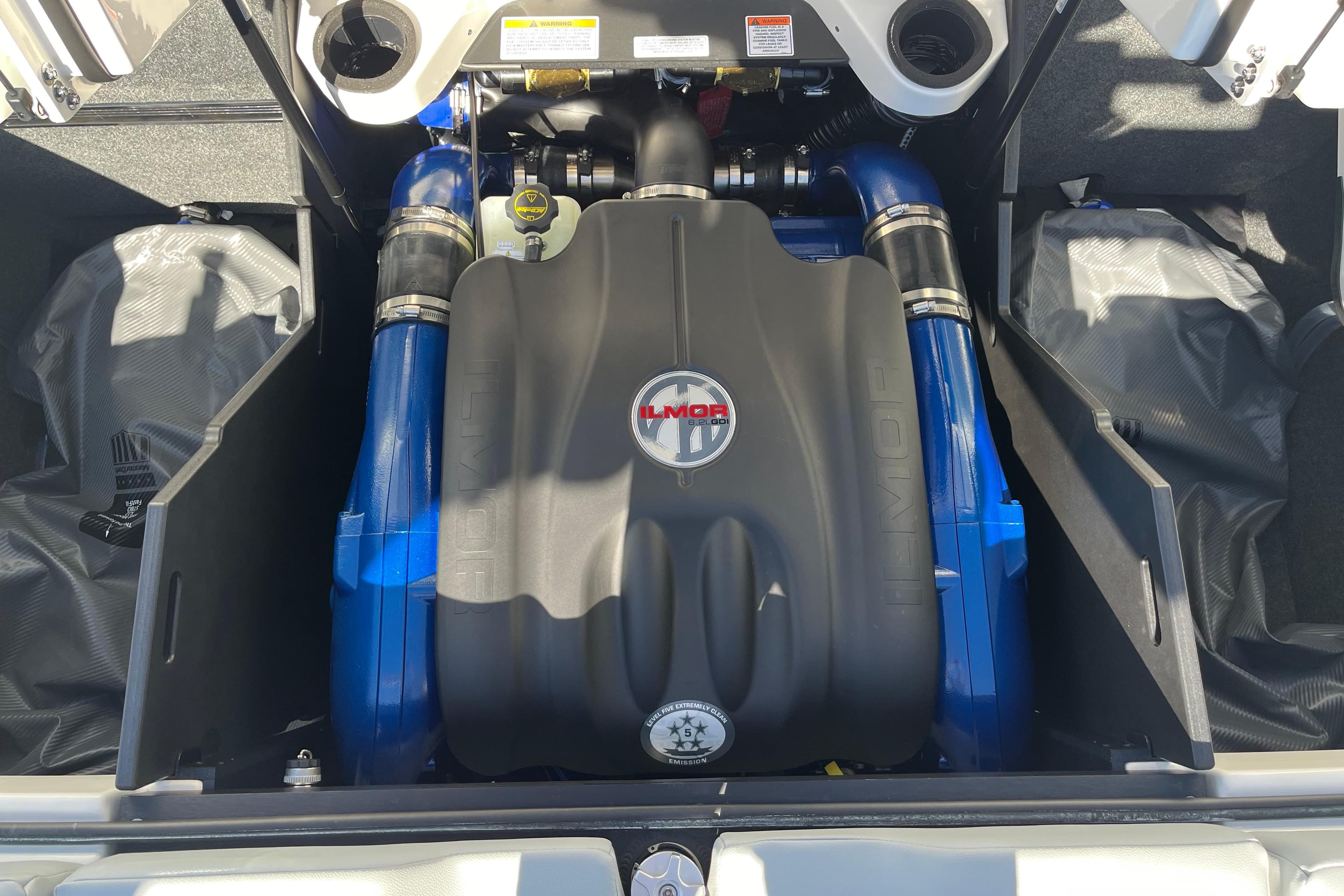 2025 MasterCraft X22 engine compartment with Ilmor engine, showcasing blue and black components.