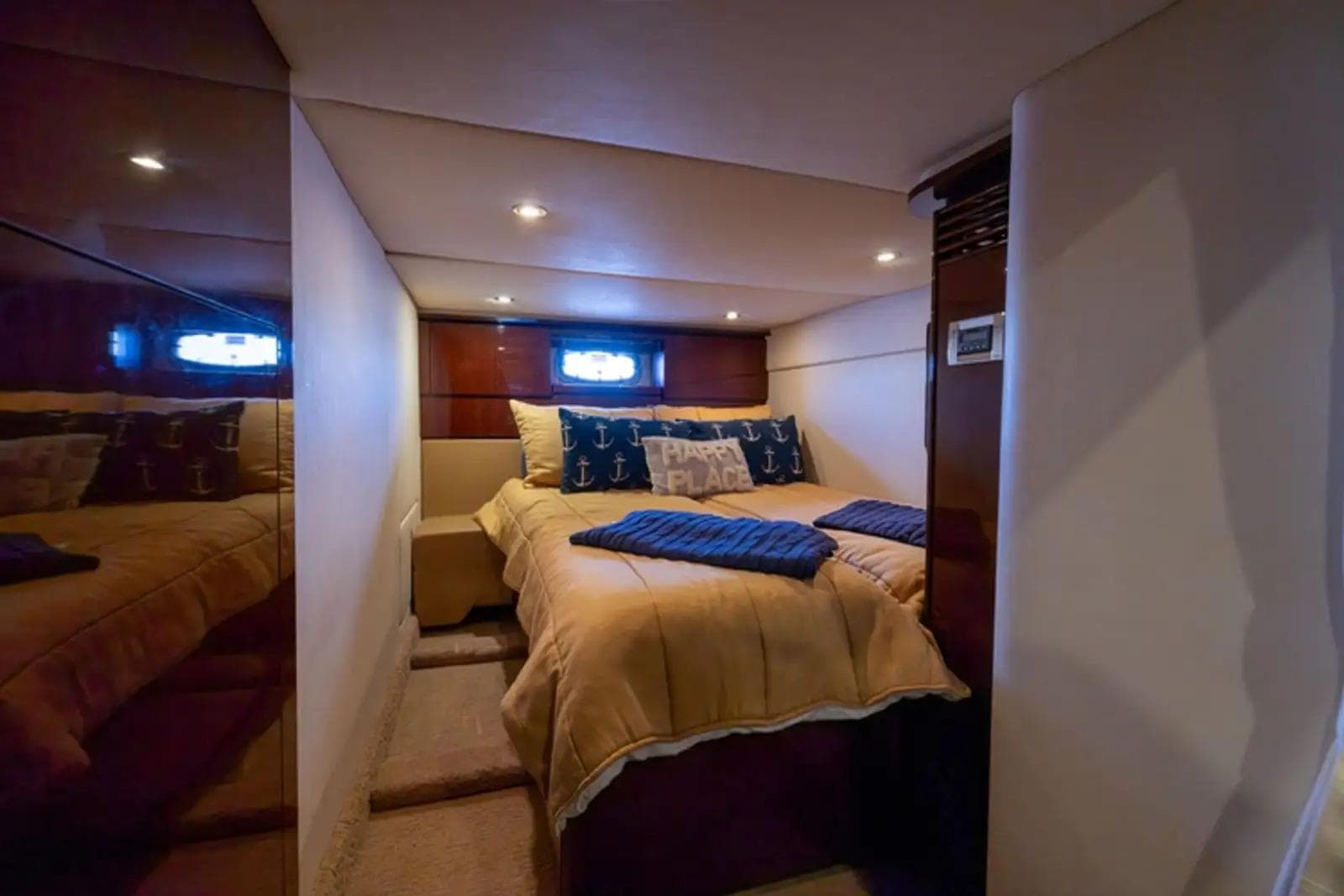 Luxurious cabin interior of 2010 Sea Ray 500 Sundancer yacht with cozy bedding.