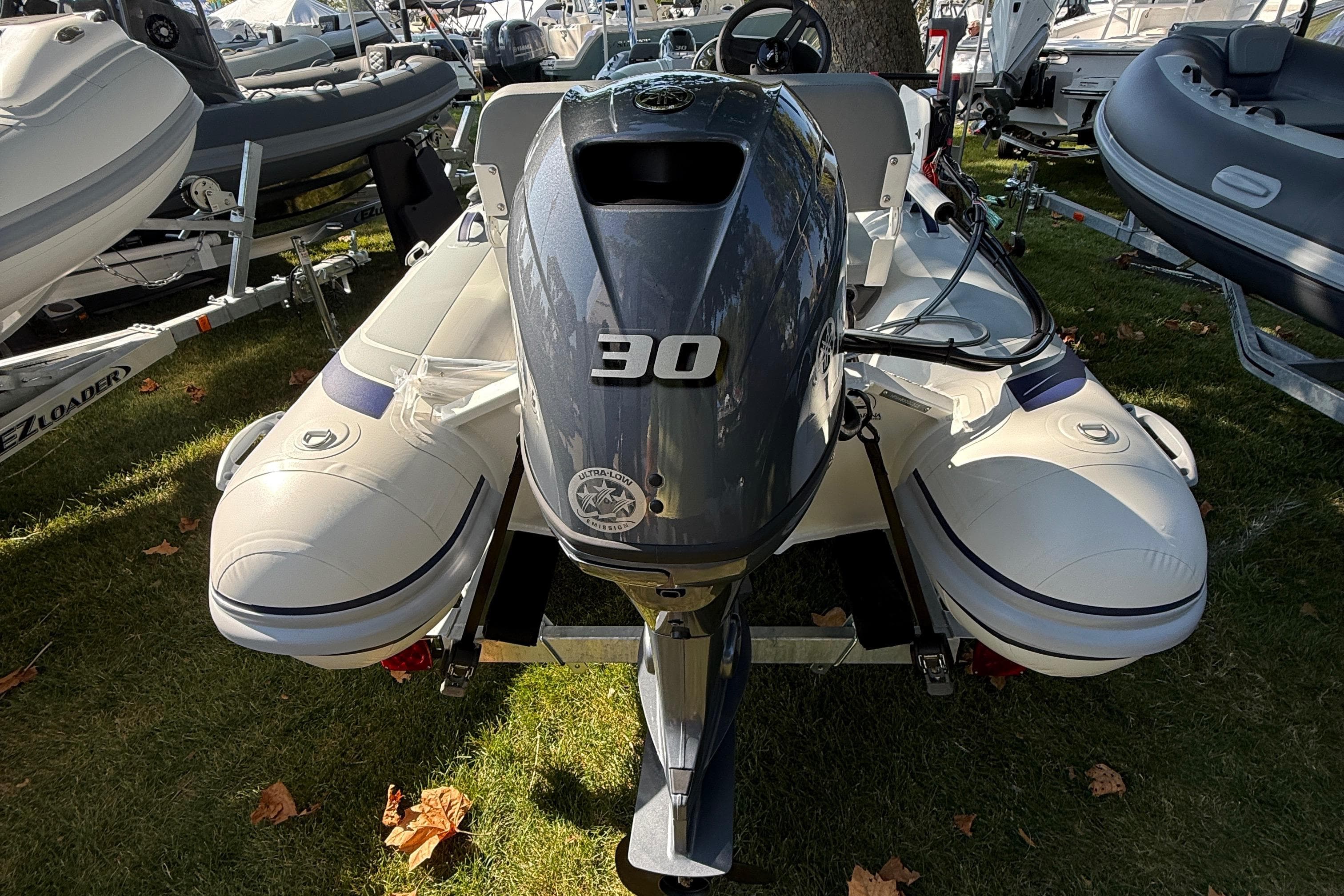 2025 Highfield Classic 380 inflatable boat with 30 HP outboard motor on display.