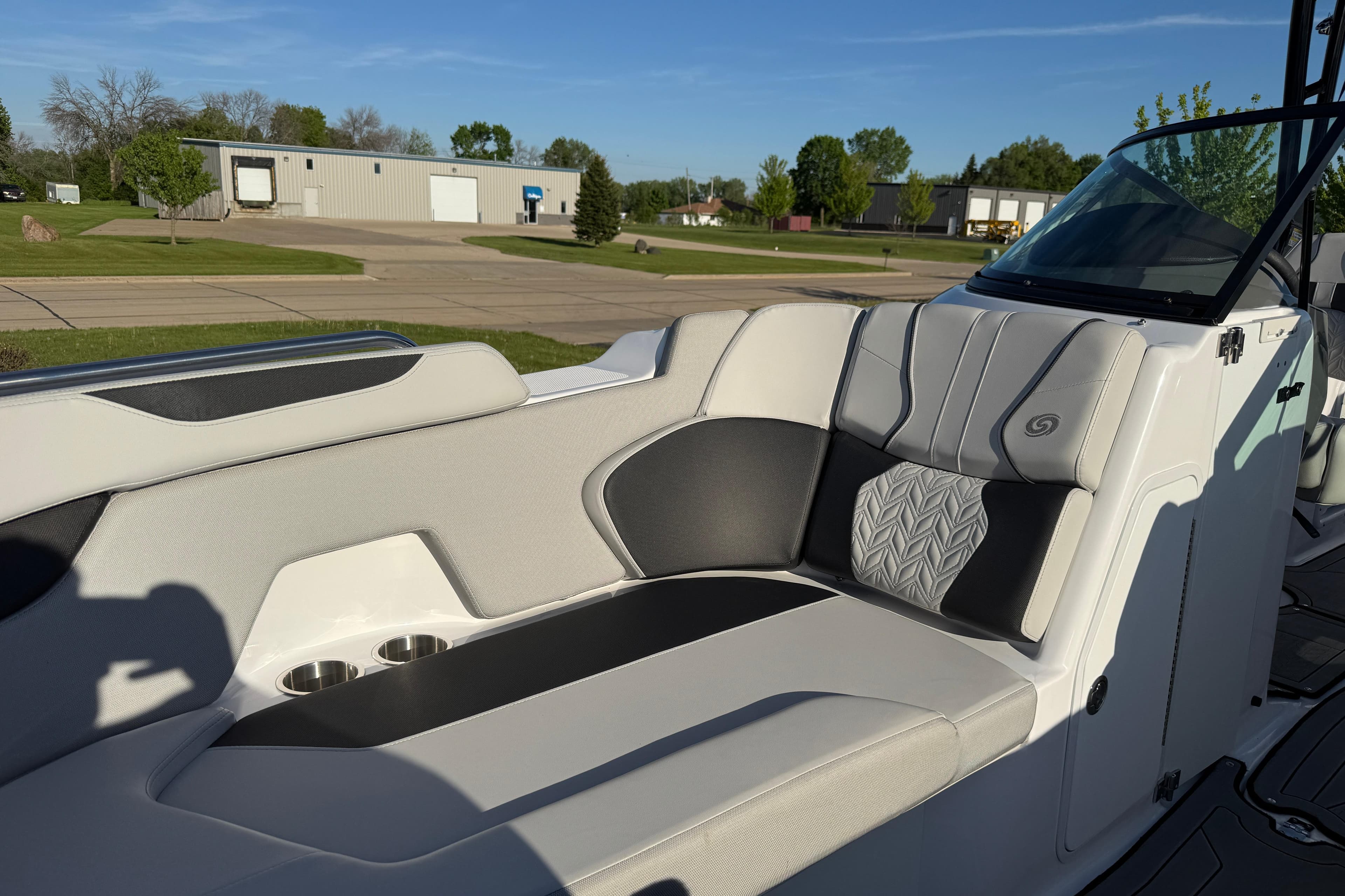 2025 Hurricane SunDeck 2400 OB boat interior with stylish seating and cup holders.