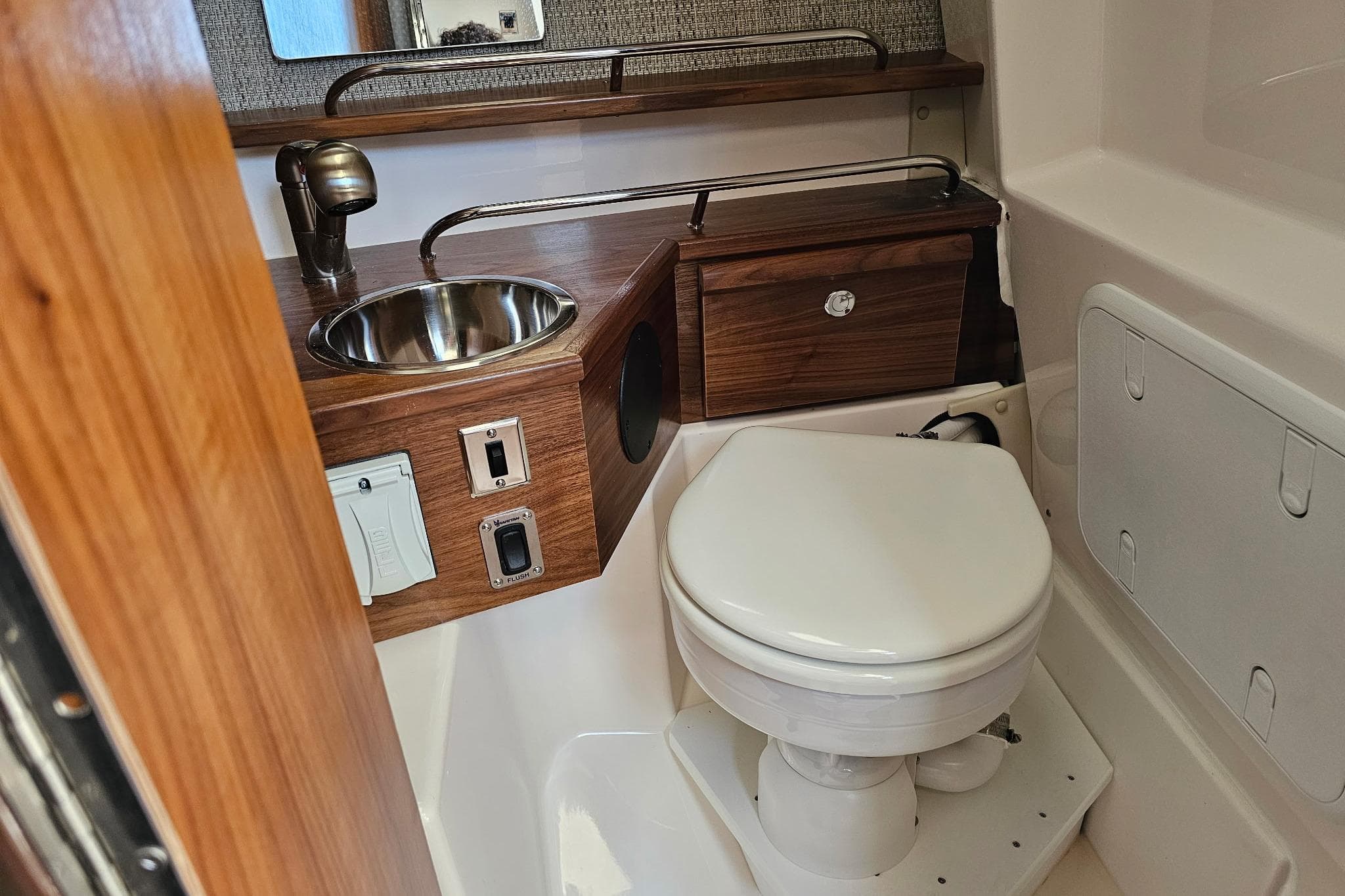 Compact bathroom in 2026 Solara S-250 Coupe with sink and toilet.