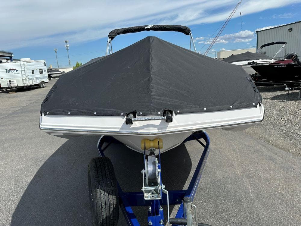 2024 Starcraft SVX 211 OB boat with black cover on trailer.