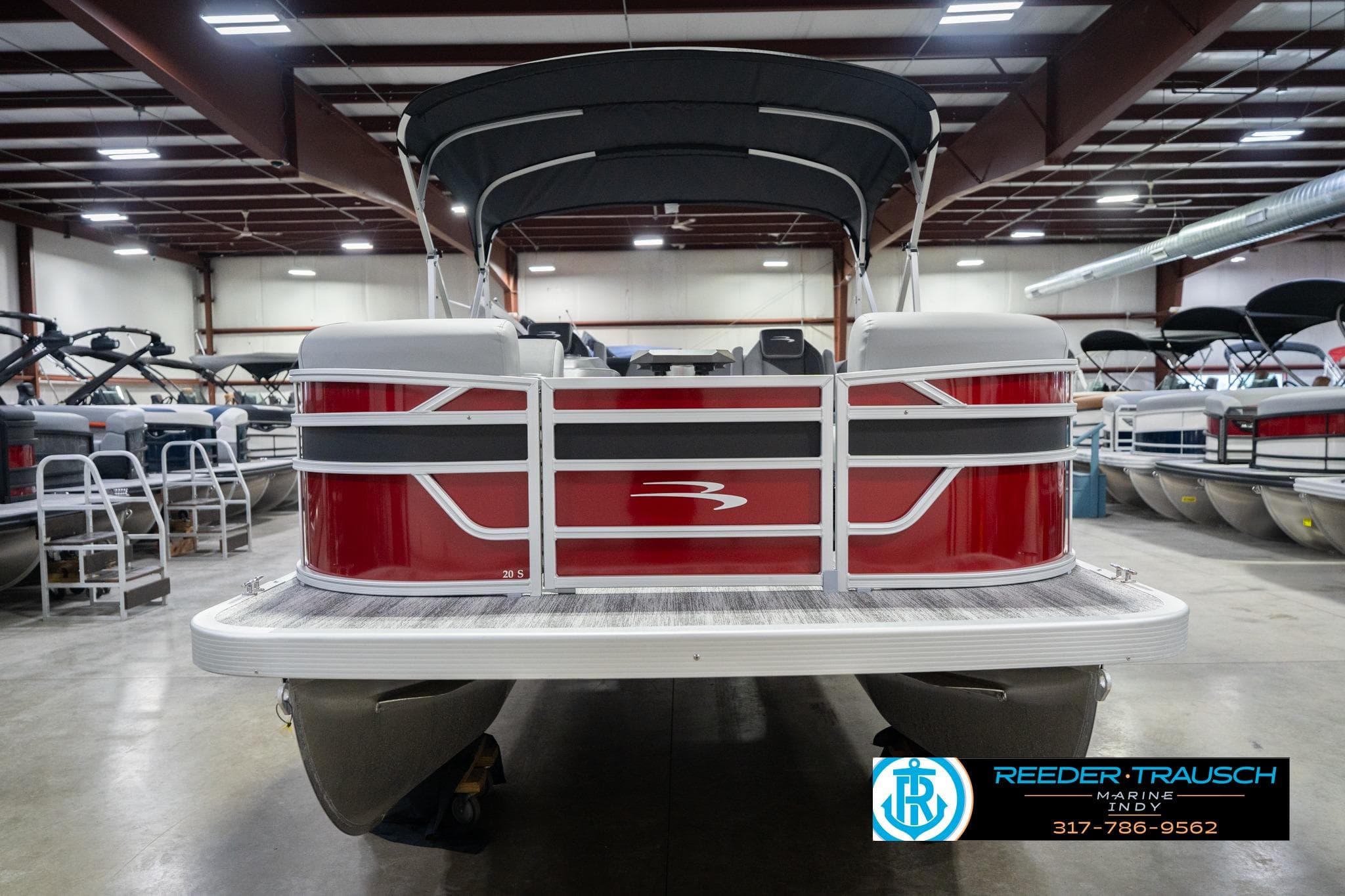 2026 Bennington 20 SSR pontoon boat in showroom, rear view with canopy.