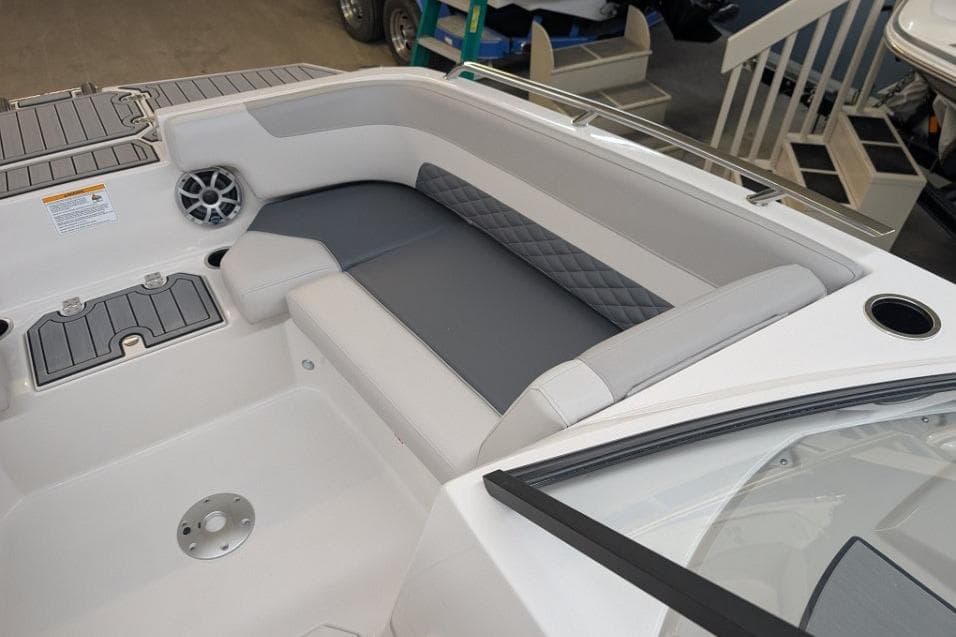 Interior of 2025 Starcraft SVX 210 IO boat with gray seating and speaker.