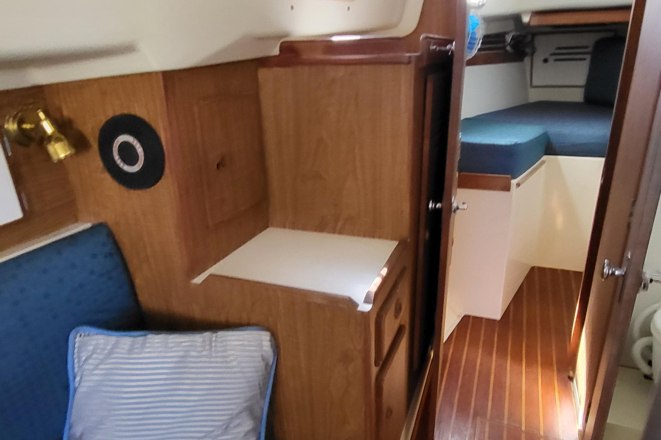 Interior of 1979 Pearson 365 Sloop, featuring cozy cabin with wood paneling and seating.