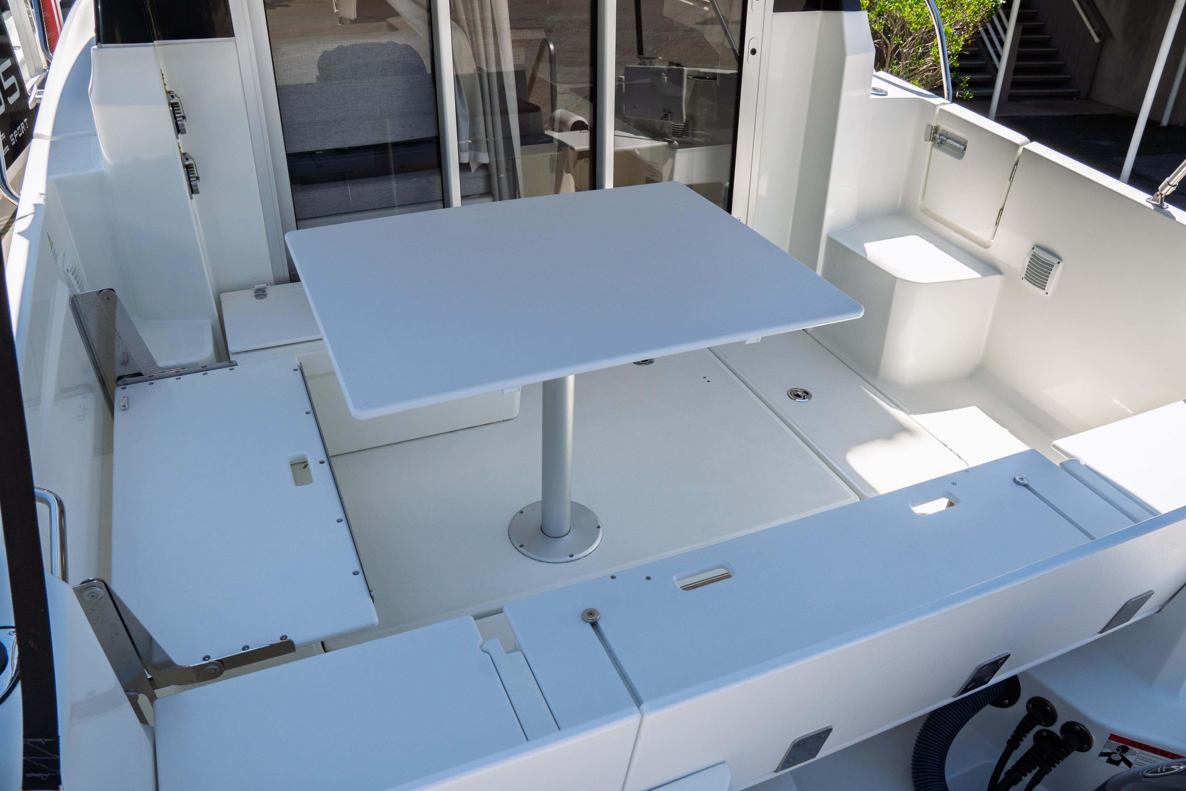 2023 Jeanneau NC Weekender 795 Series 2 boat interior with table and seating area.