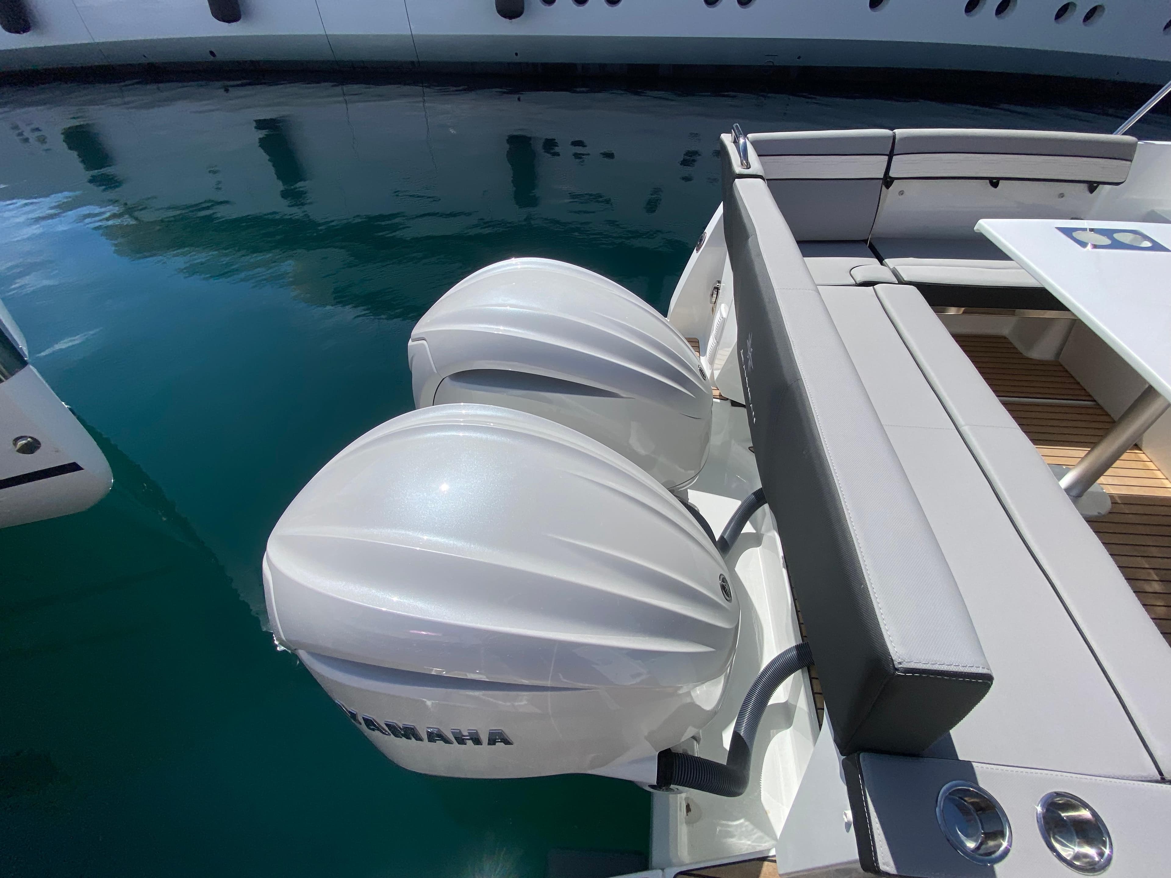 2025 Jeanneau MERRY FISHER 895 S2 with Yamaha outboard motors docked on calm water.