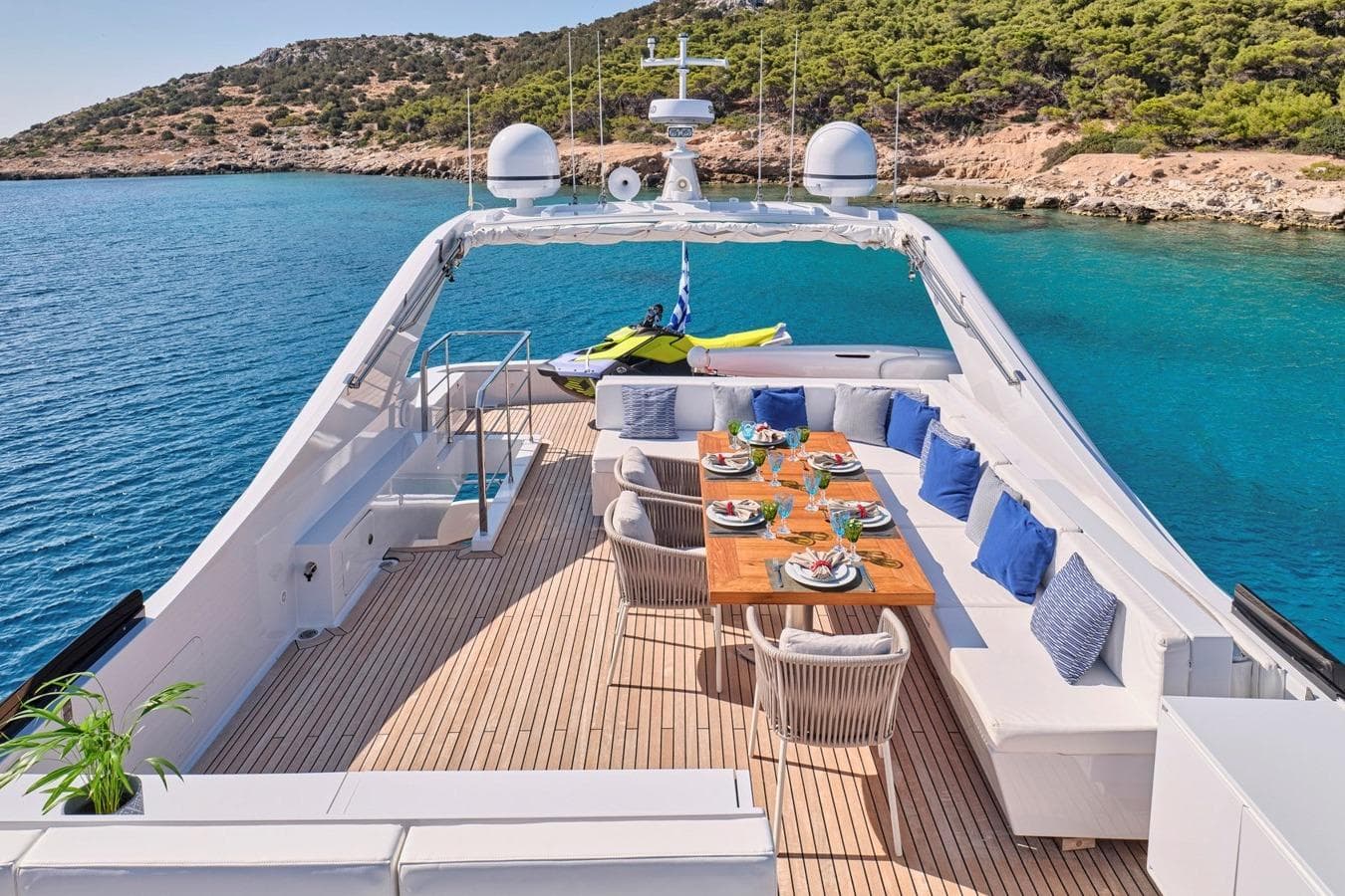 Luxurious Admiral 25 yacht deck with dining area, surrounded by clear blue waters, 2008 model.