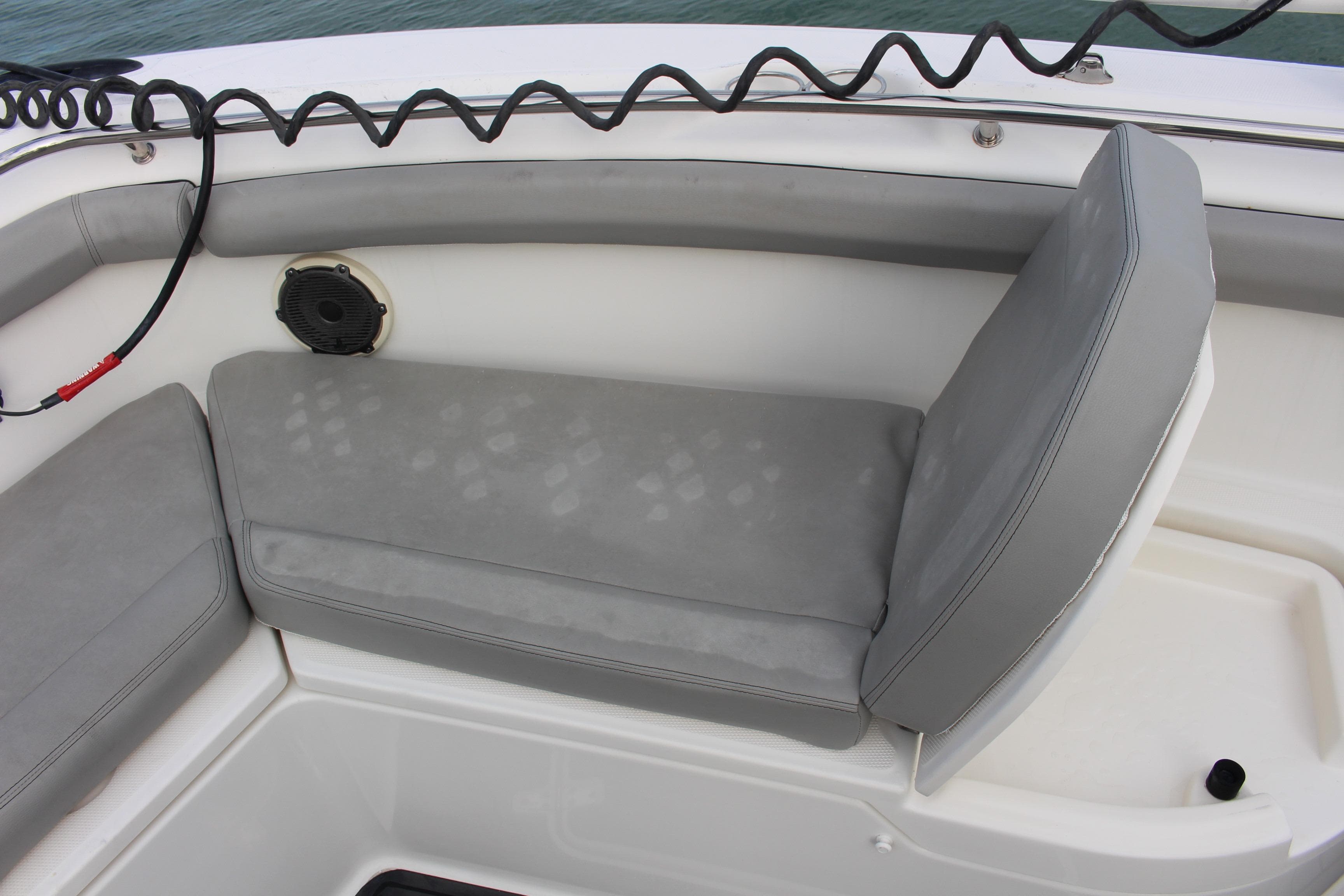 Boston Whaler 350 Outrage 2020 boat seating with gray cushions and speaker.
