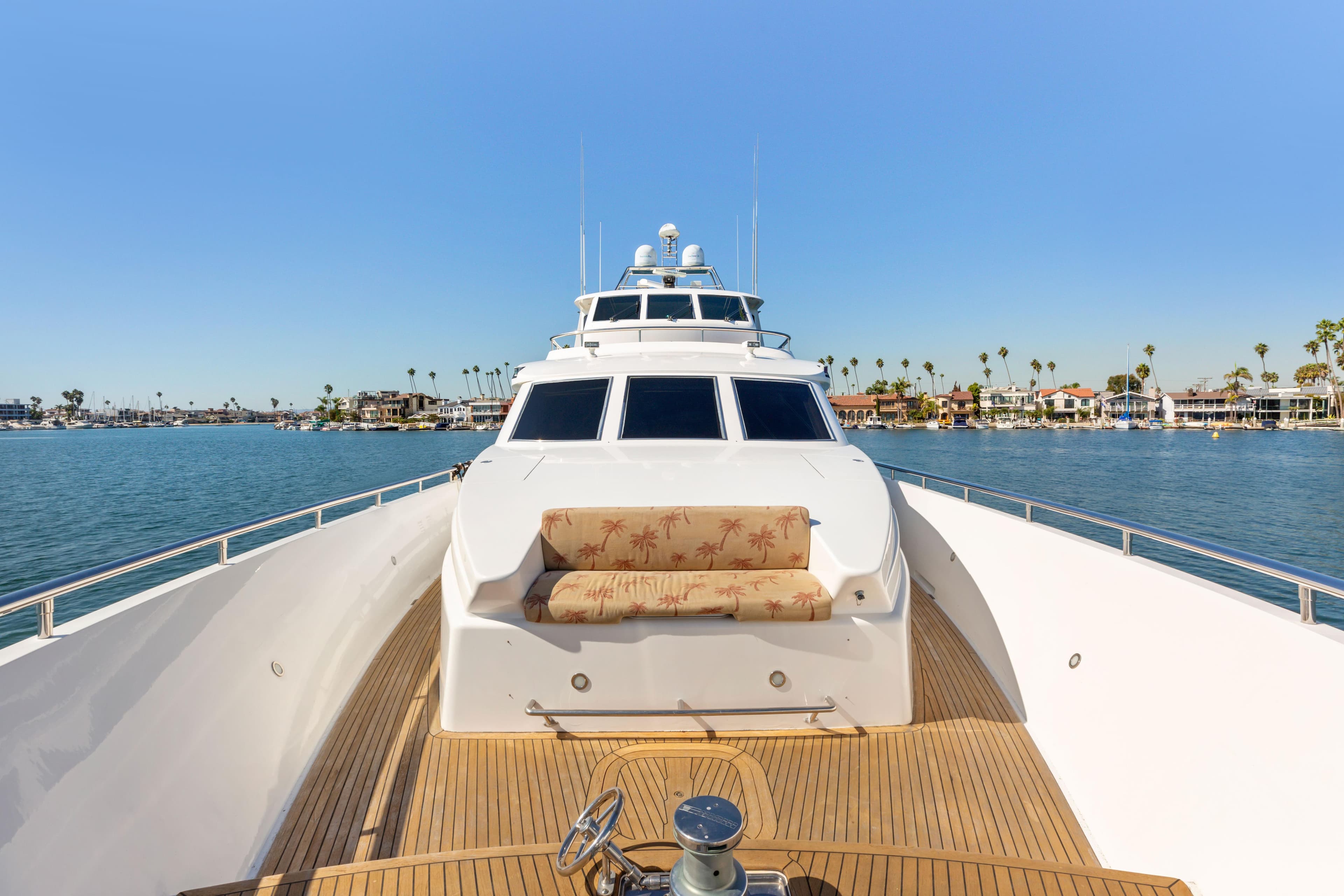 Luxurious 2005 Custom yacht on serene water with clear blue sky.