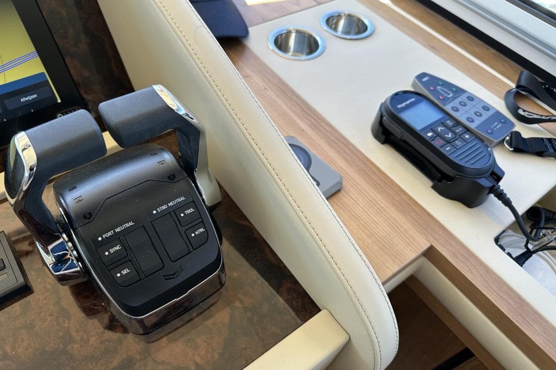 Control panel of 2026 Linssen Grand Sturdy 550 Variotop yacht with throttle and navigation devices.