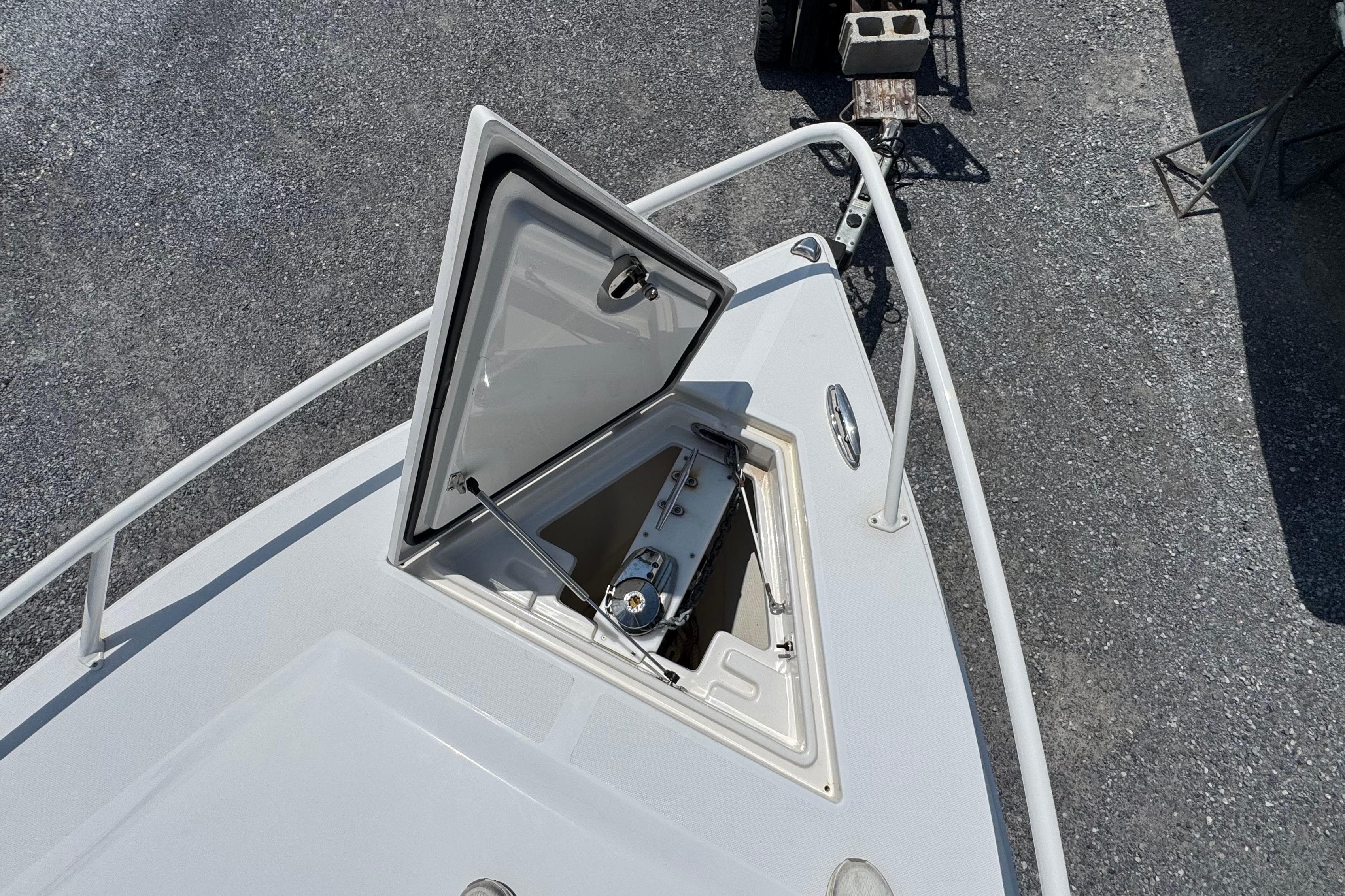 Open hatch on 2013 Jupiter 32 Cuddy boat, revealing anchor storage compartment.
