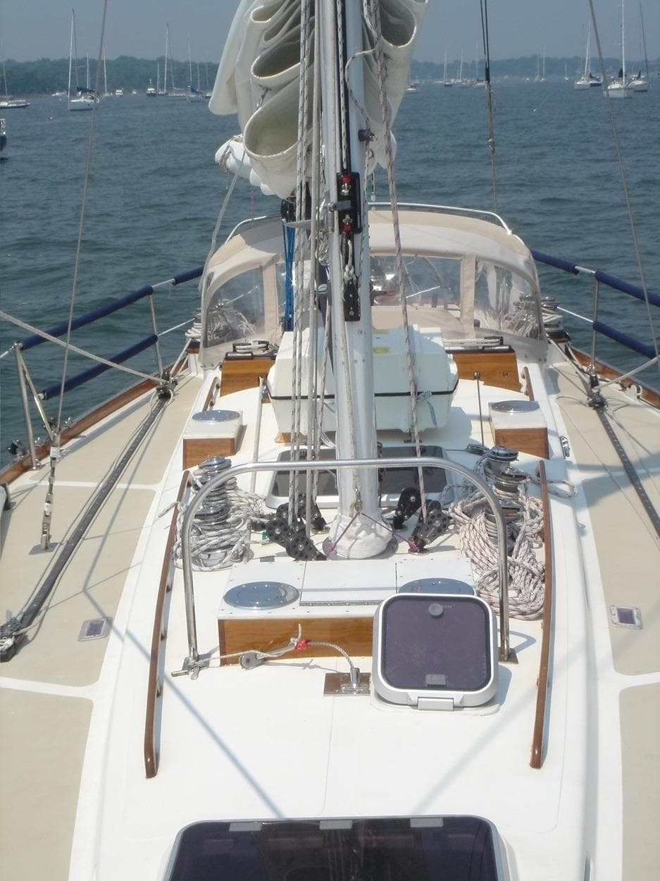 1980 Hinckley 43 sailboat deck with rigging and ropes on a calm sea.