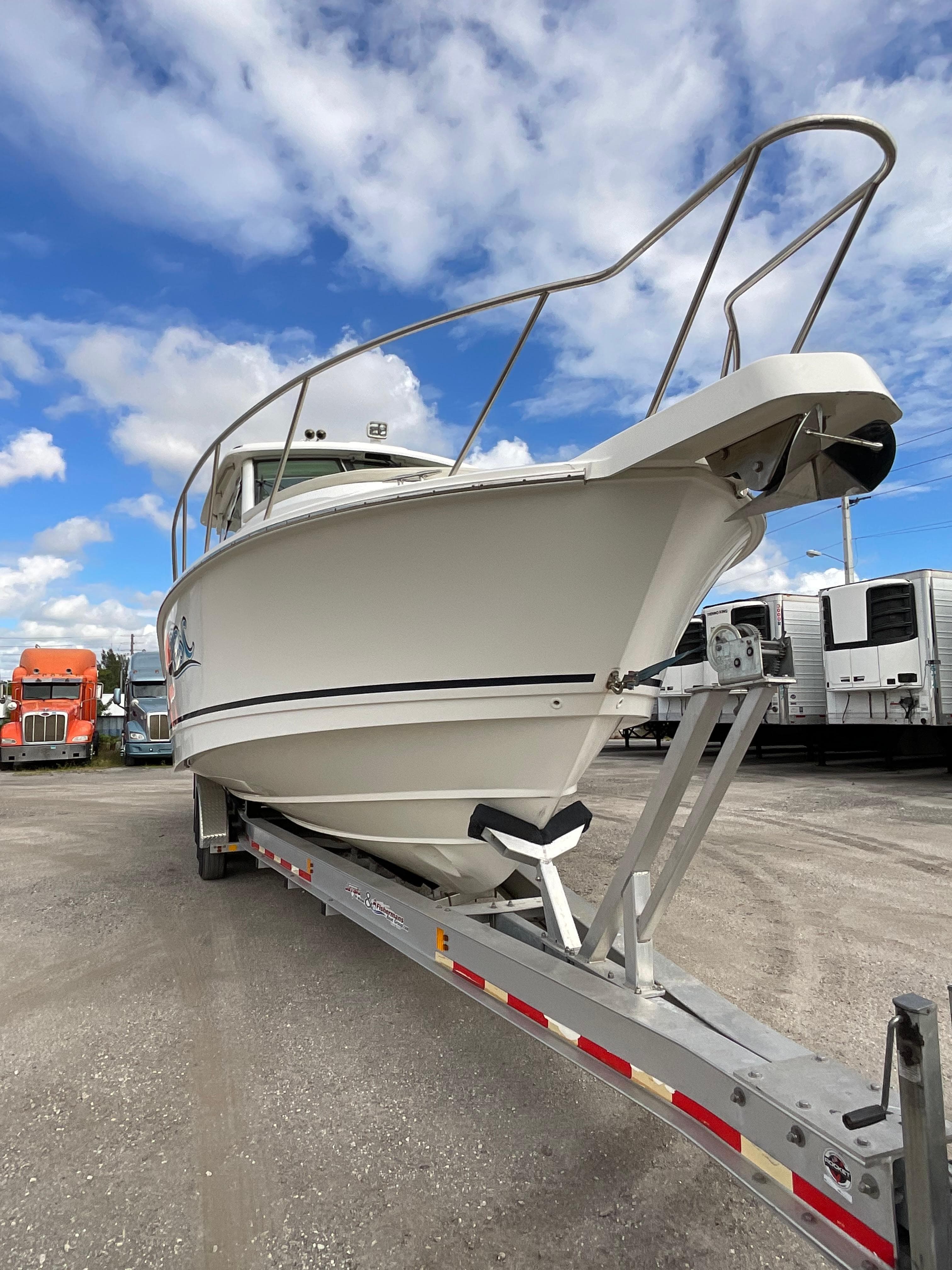 2019 Boston Whaler 345 Conquest boat on trailer under blue sky.