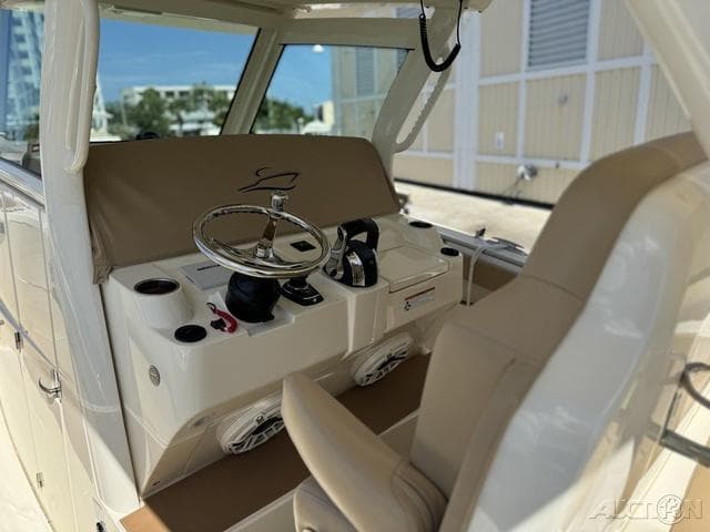 2022 Scout 330 LXF boat cockpit with steering wheel and controls.