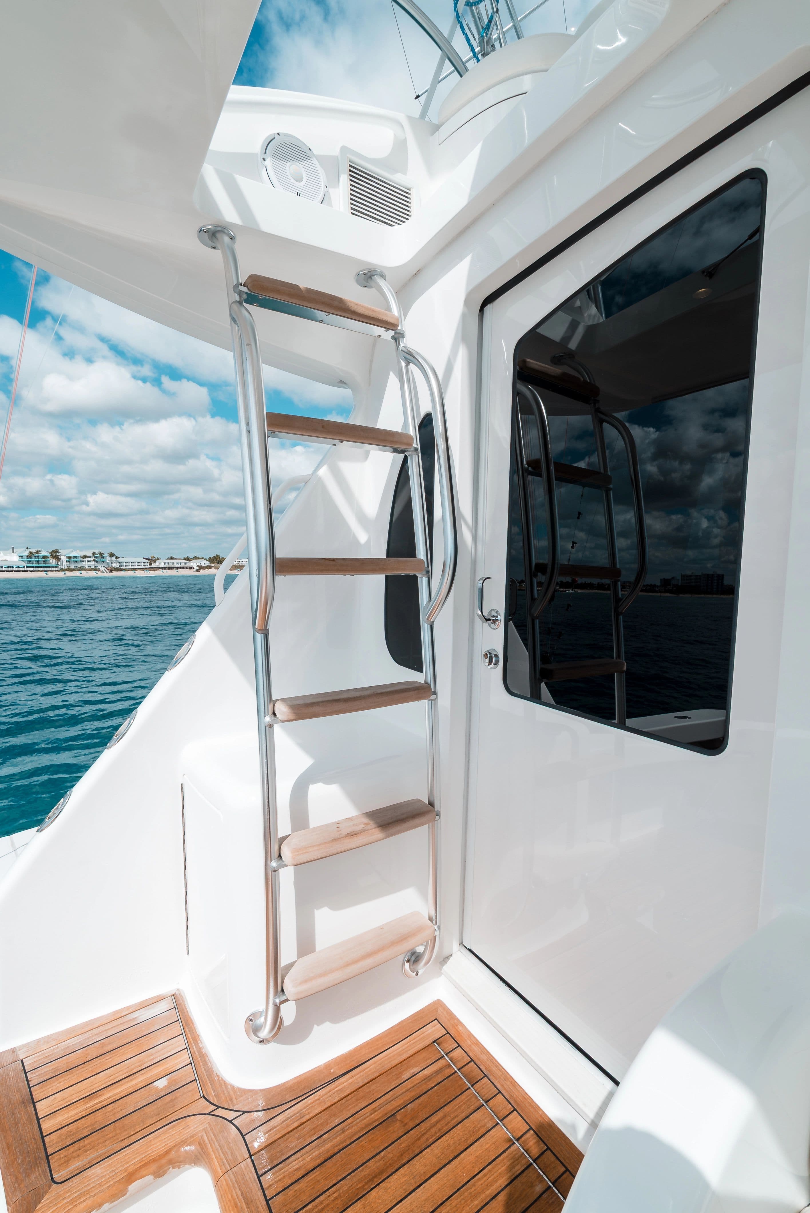 Viking 48 Convertible 2025 yacht with ladder and ocean view.