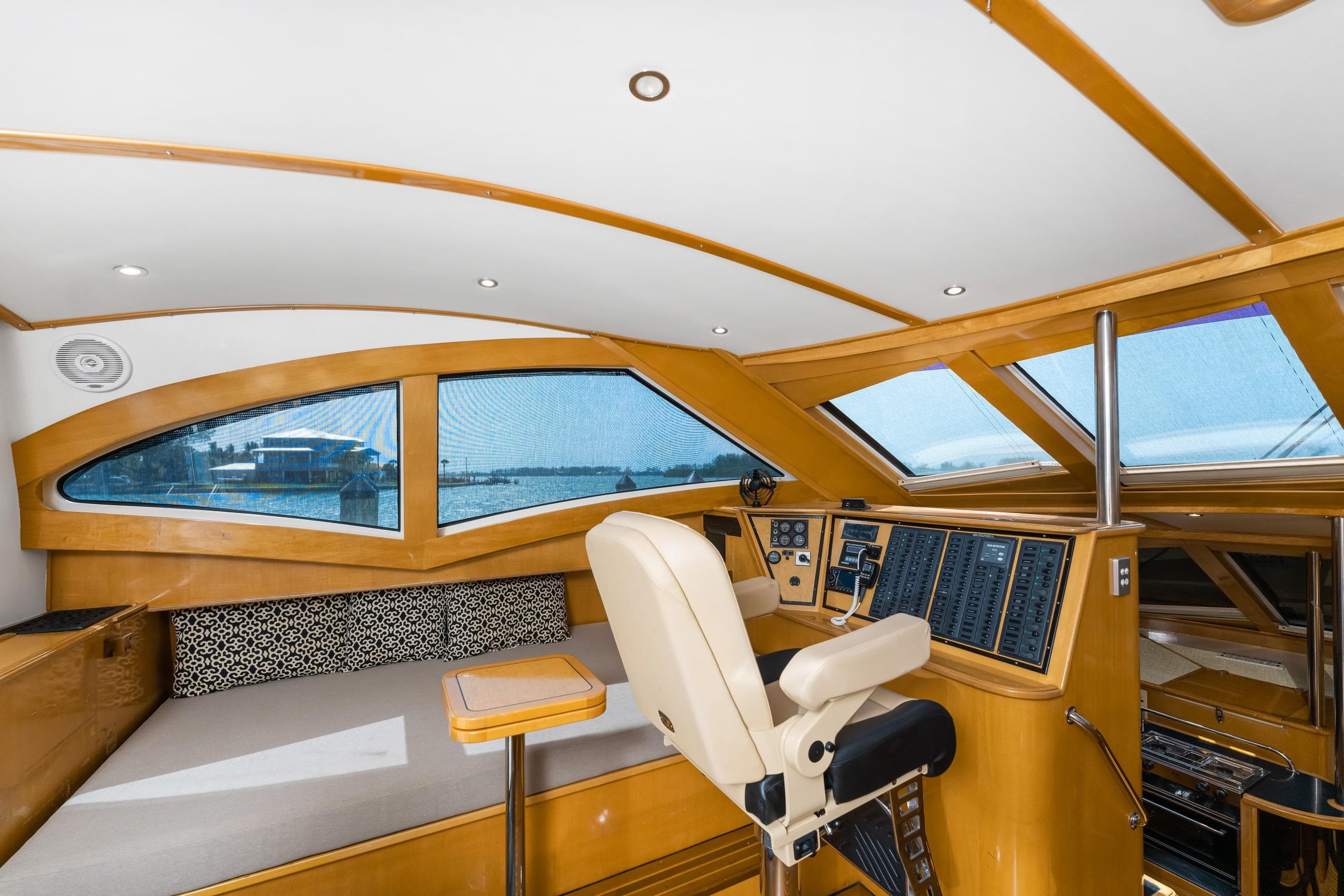 Luxurious interior of 2000 Jutson 46 LRC yacht with modern helm and panoramic windows.