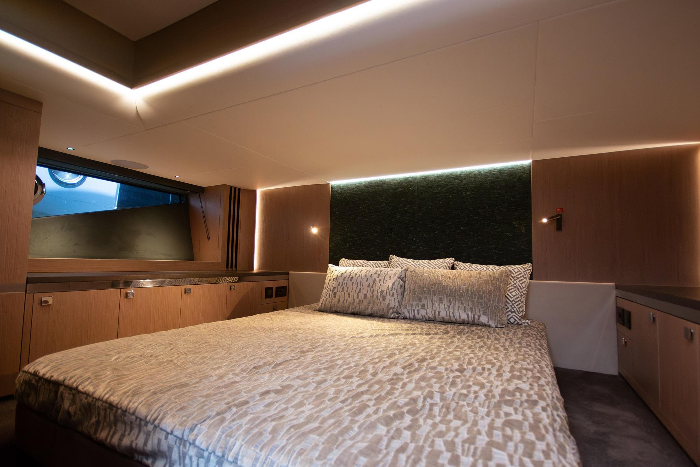 Luxurious bedroom interior of 2024 Sunseeker Superhawk 55 yacht with modern design.