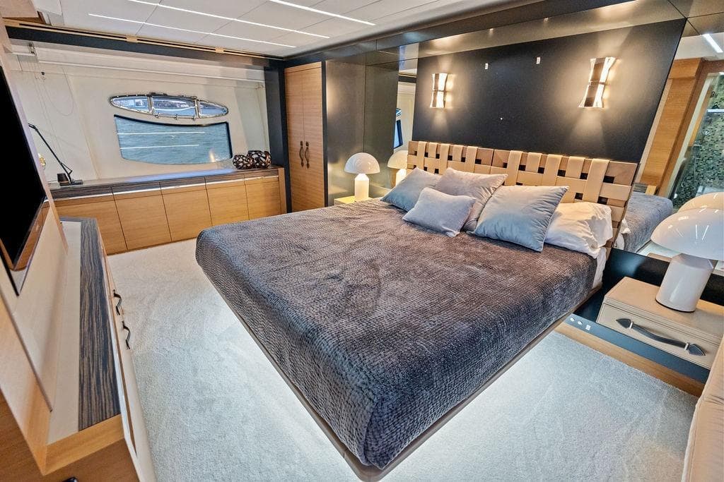 Luxurious bedroom interior of 2012 Pershing 92 yacht with modern design and elegant furnishings.