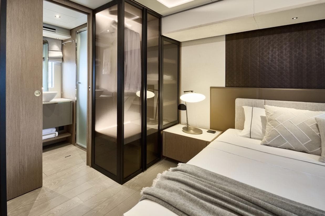 Luxurious Prestige M7 2025 yacht bedroom with modern design and ensuite bathroom.
