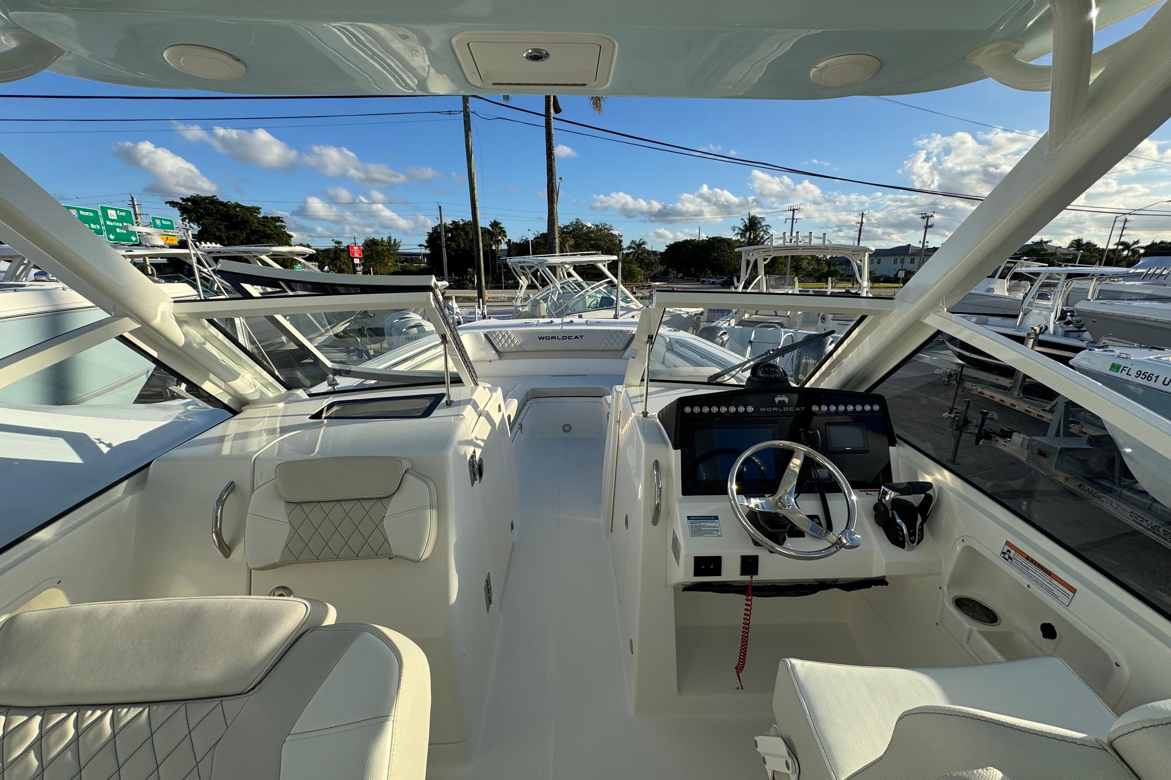 2026 World Cat 280 DC-X boat interior with modern helm and seating under clear skies.