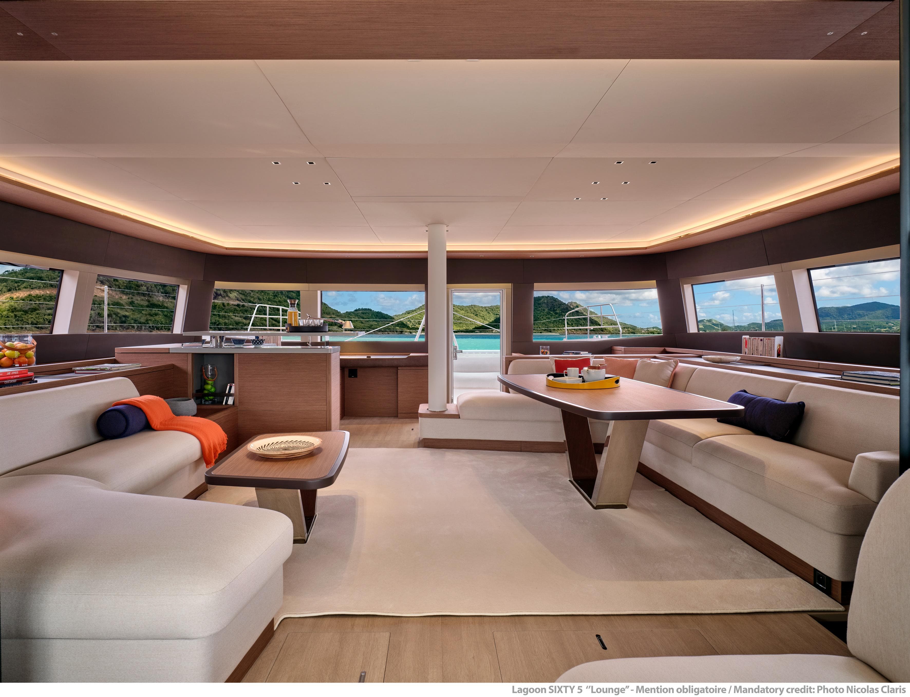 Luxurious interior of 2025 Lagoon Sixty5 yacht with elegant seating and panoramic windows.