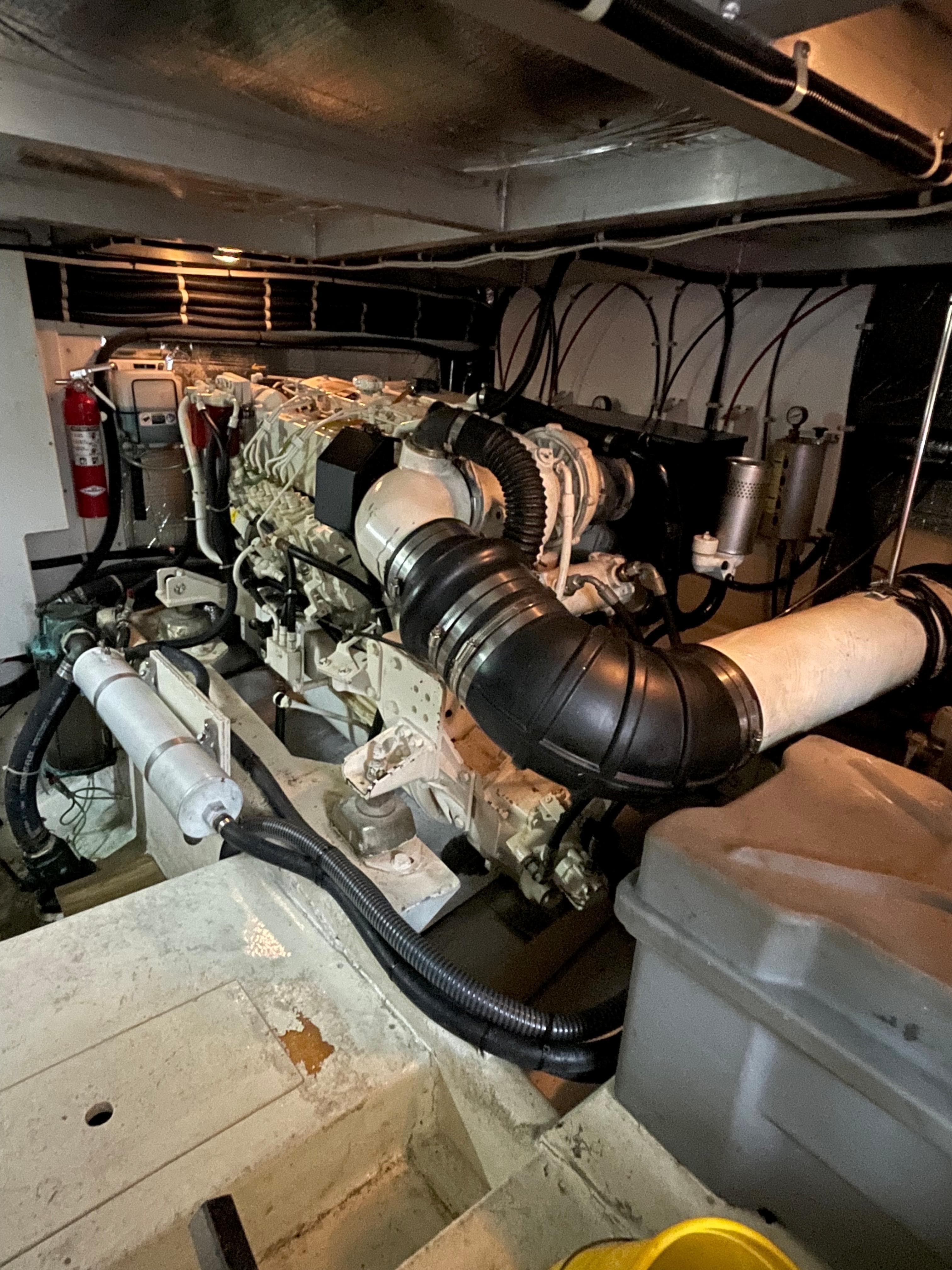 Engine room of 2001 Navigator Californian 3900 yacht, featuring complex machinery and piping.