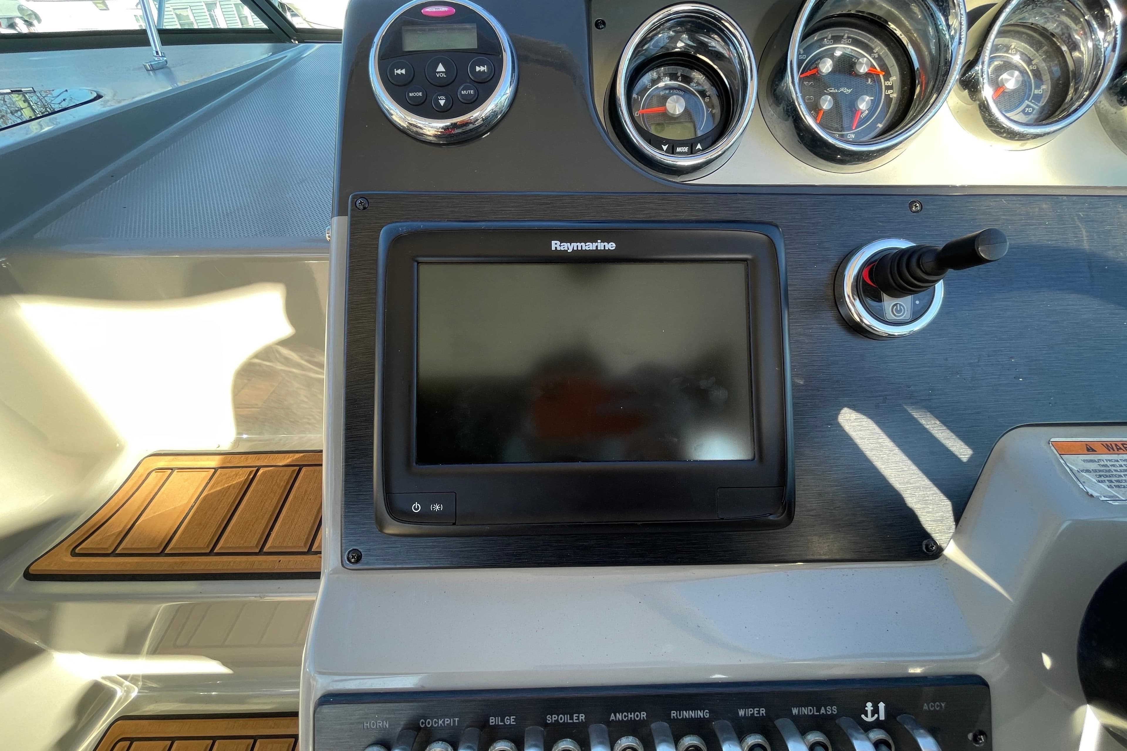 Control panel of 2016 Sea Ray 310 Sundancer with Raymarine display and gauges.