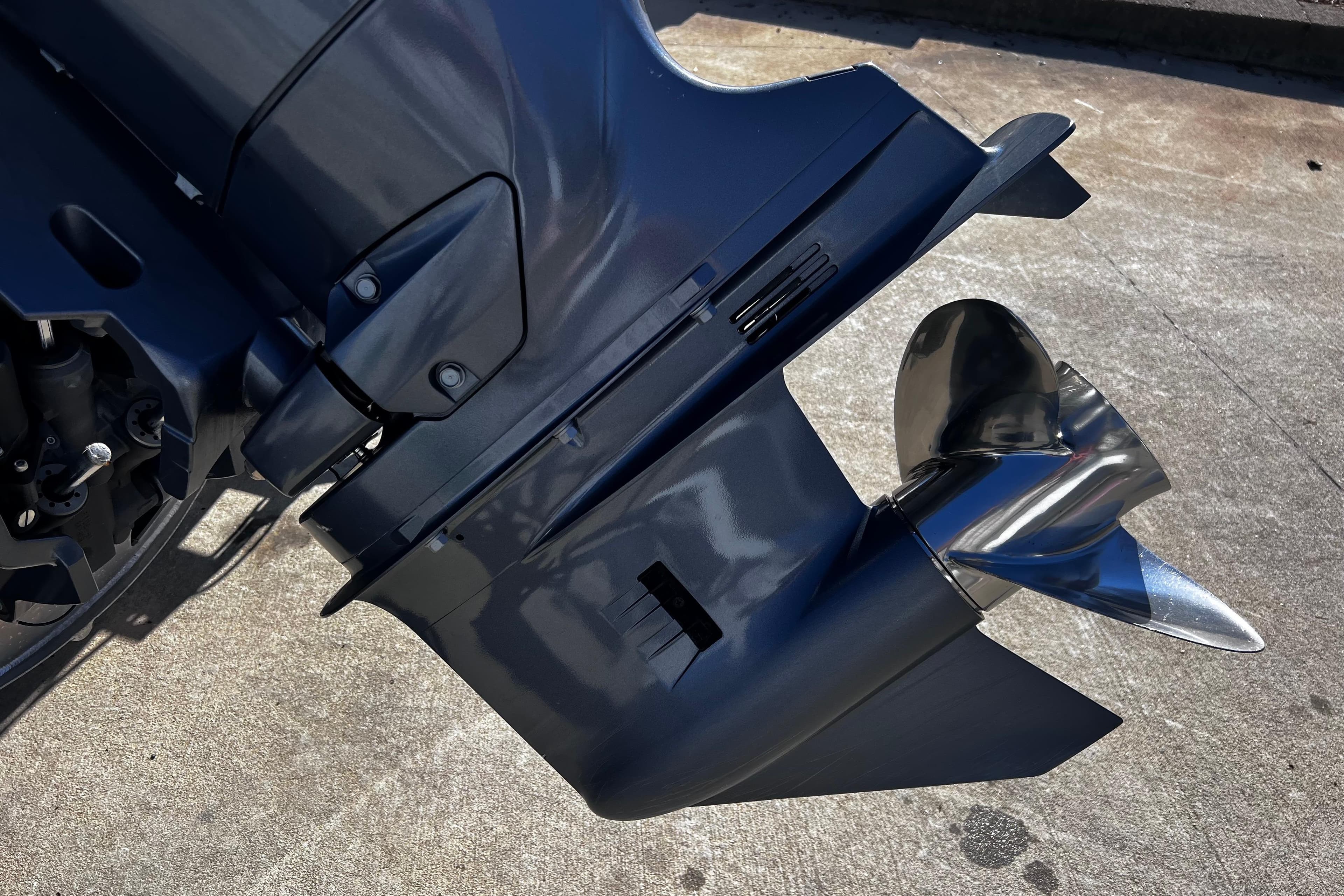 Close-up of a 2022 Godfrey Monaco 235 SFL boat motor and propeller.