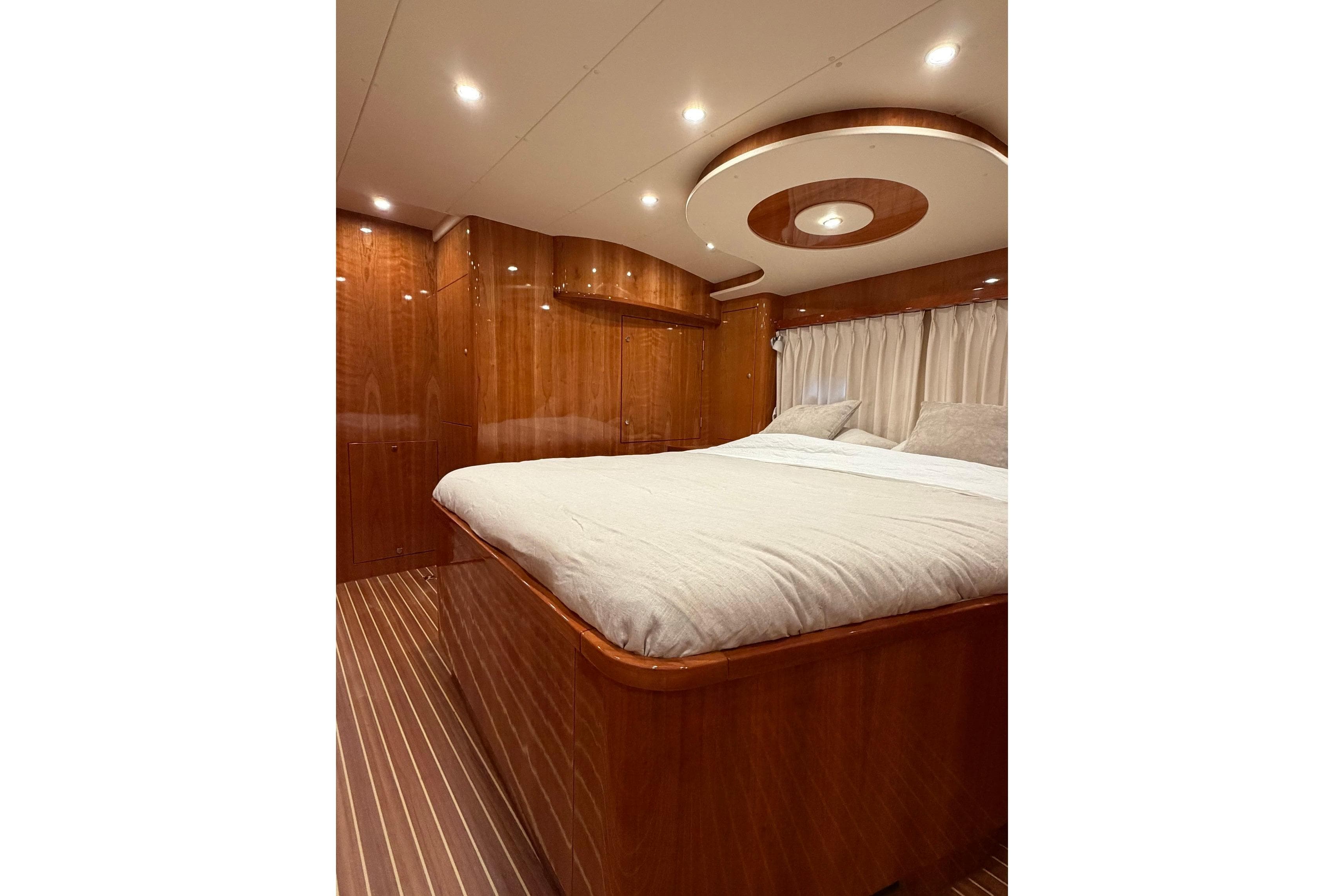 Luxurious bedroom interior of 2017 Elling E4 yacht with elegant wood finish.