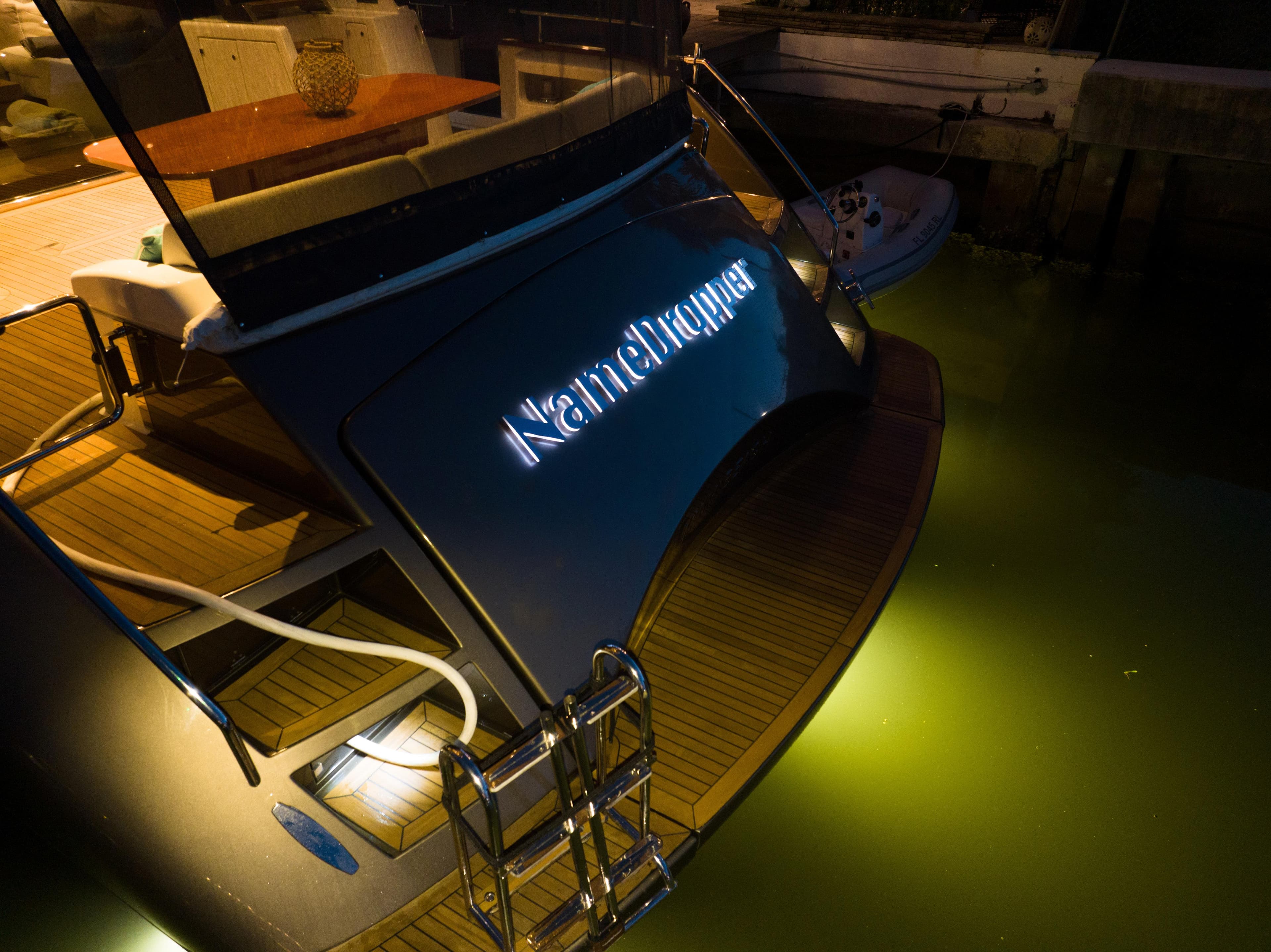 Riva 75 Venere 2012 yacht docked at night with illuminated nameplate.