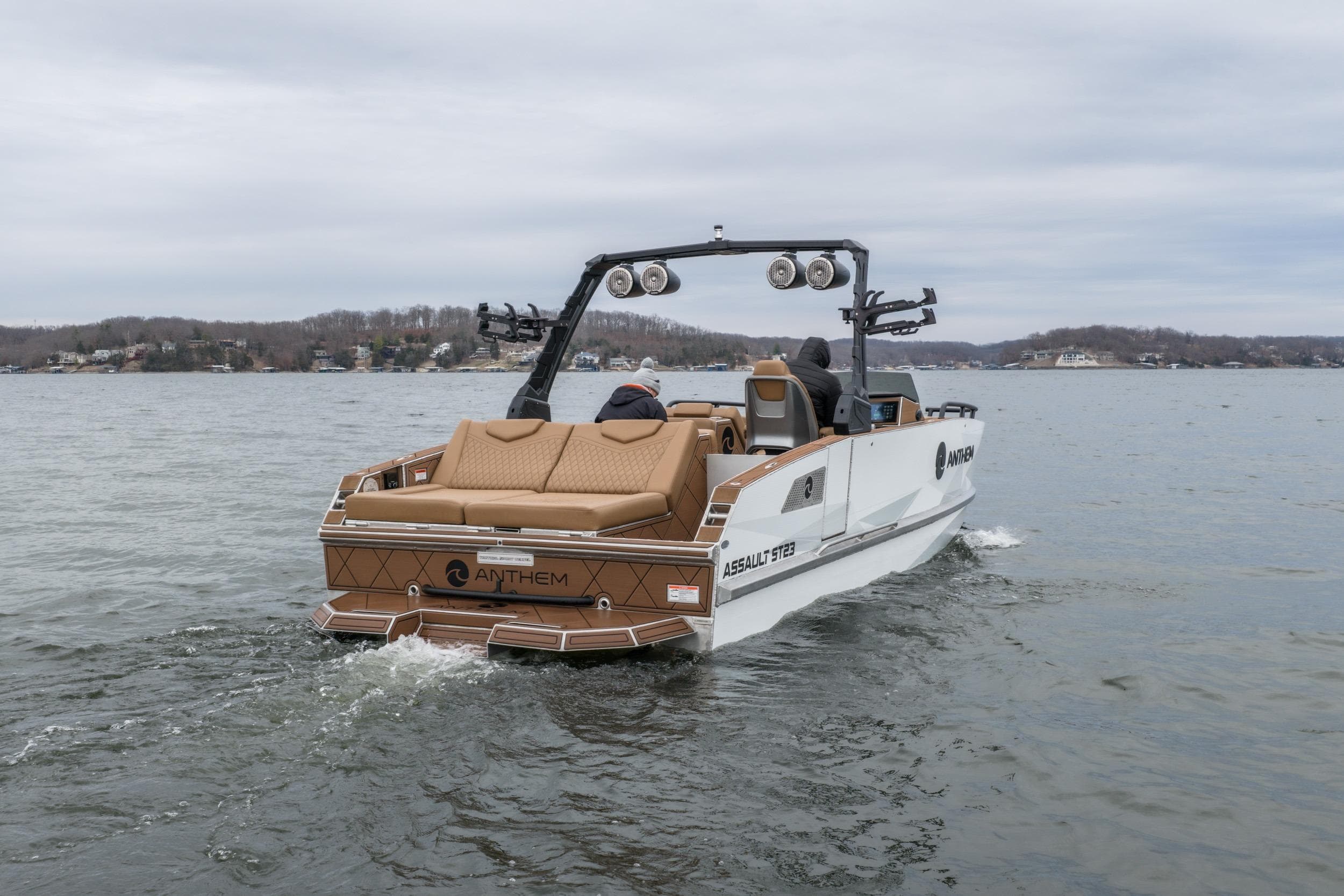 2026 Anthem Assault ST23 boat cruising on a lake under cloudy skies.