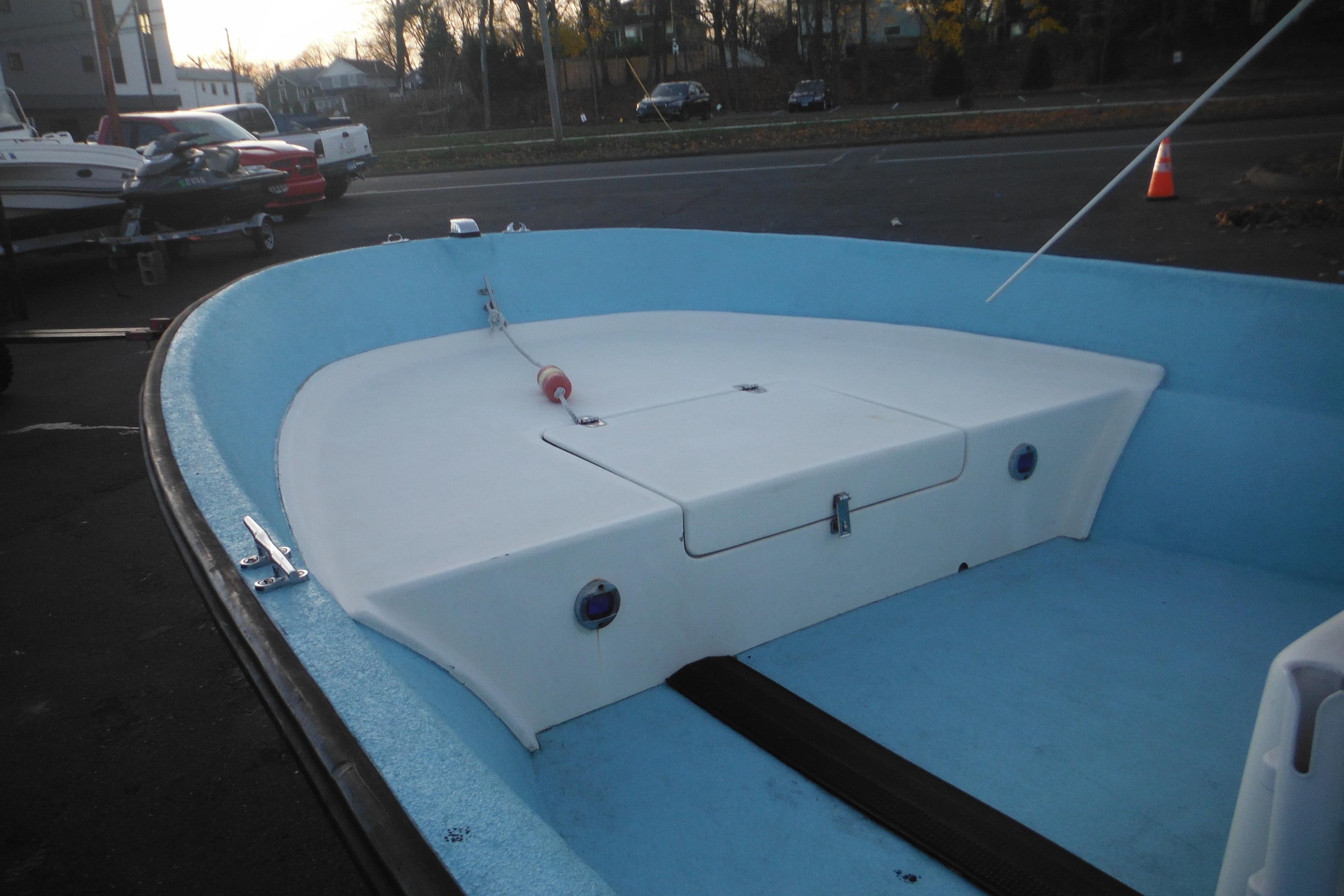 1998 Maritime Skiff 18 boat interior with blue and white design, docked outdoors.