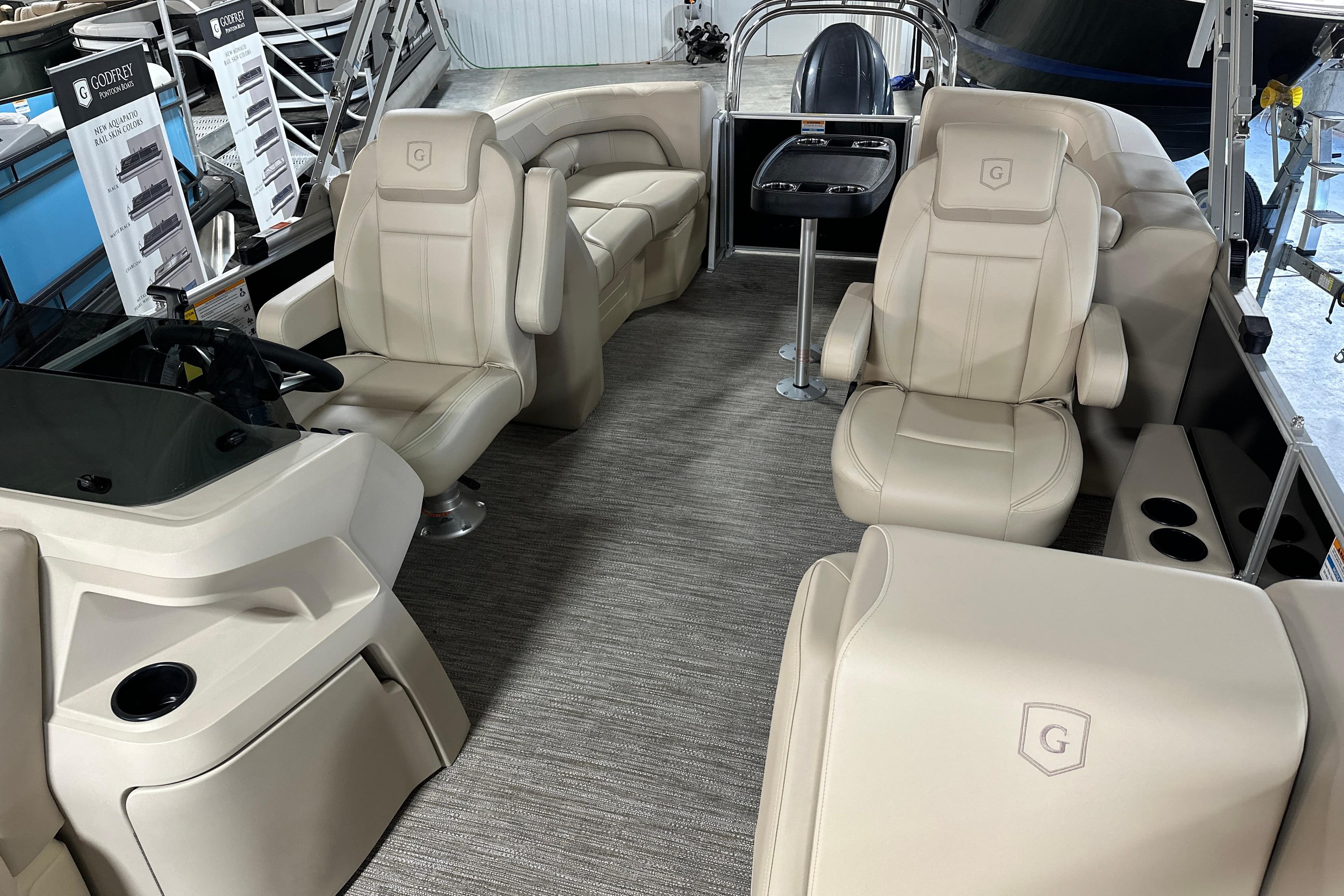 2026 Godfrey SWEETWATER 2286 SB boat interior with beige seating and modern helm.
