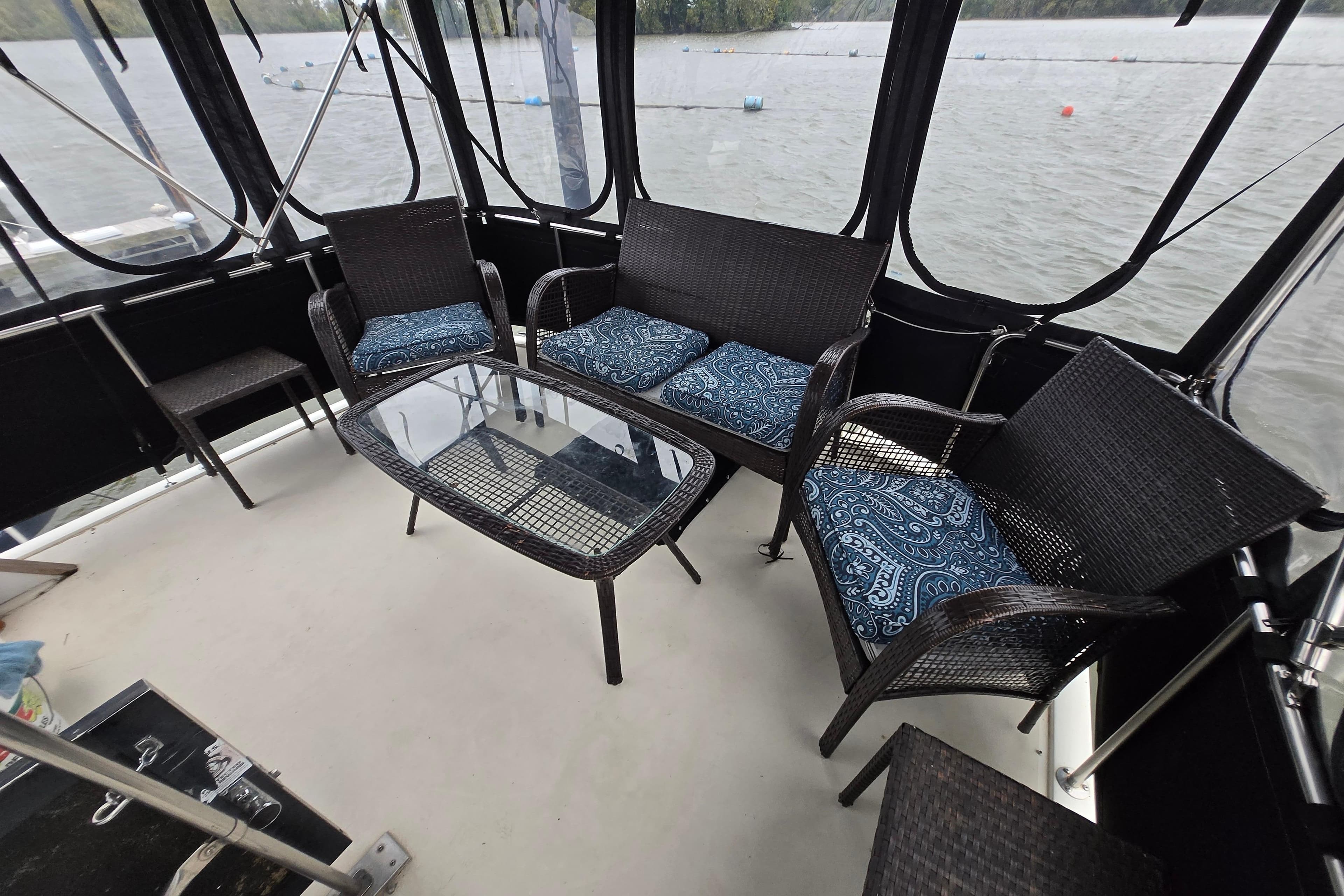1988 Mainship 36 Double Cabin with wicker seating and glass table on deck.