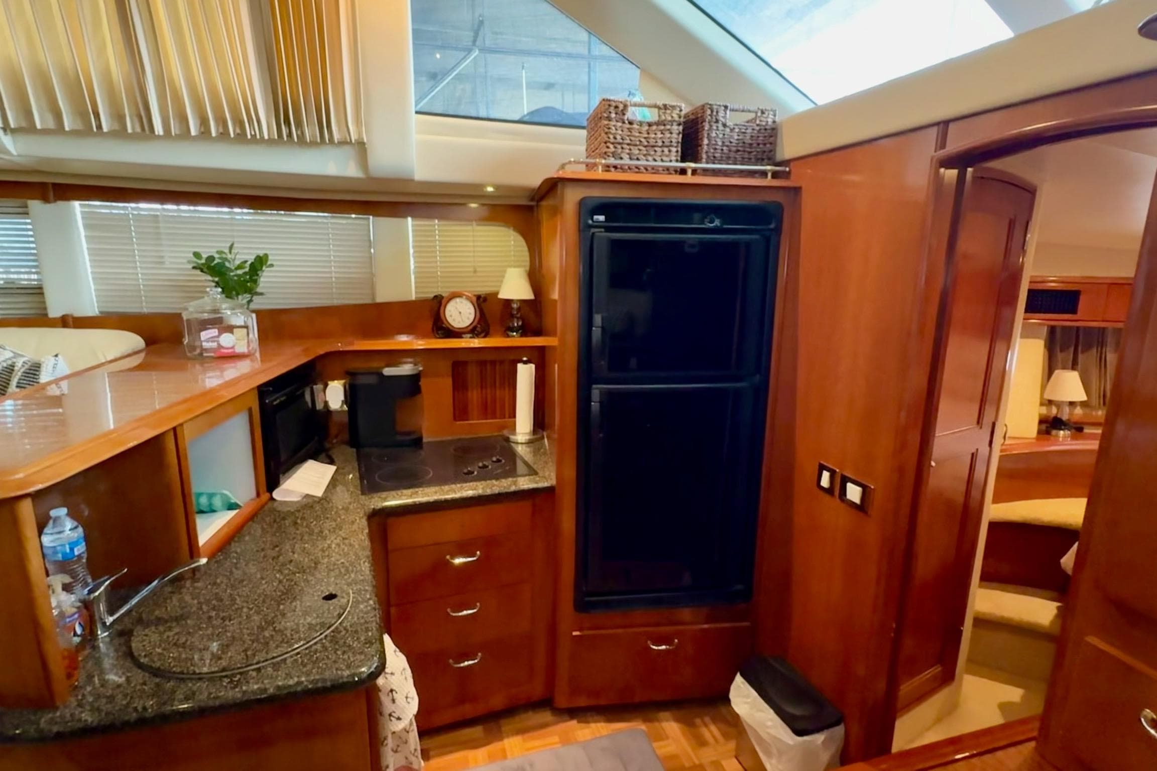 Luxurious kitchen interior of 2003 Carver 396 Motor Yacht with wood cabinetry and modern appliances.