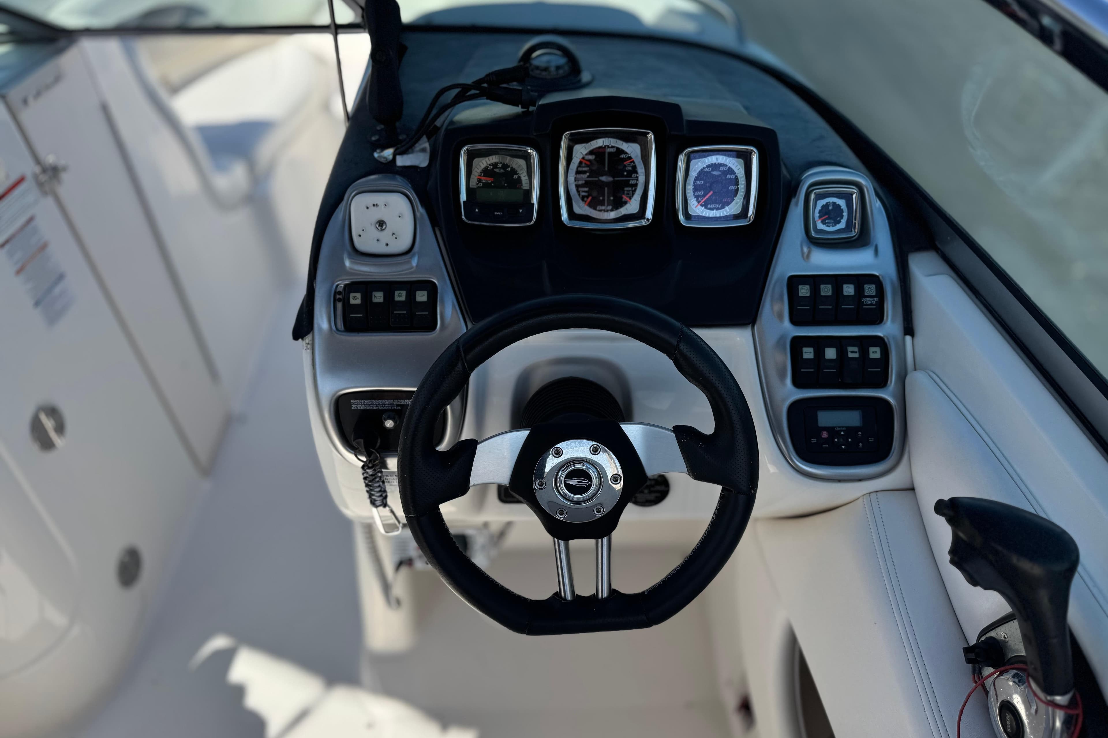 Cockpit view of 2011 Chaparral 267 SSX boat with steering wheel and dashboard controls.