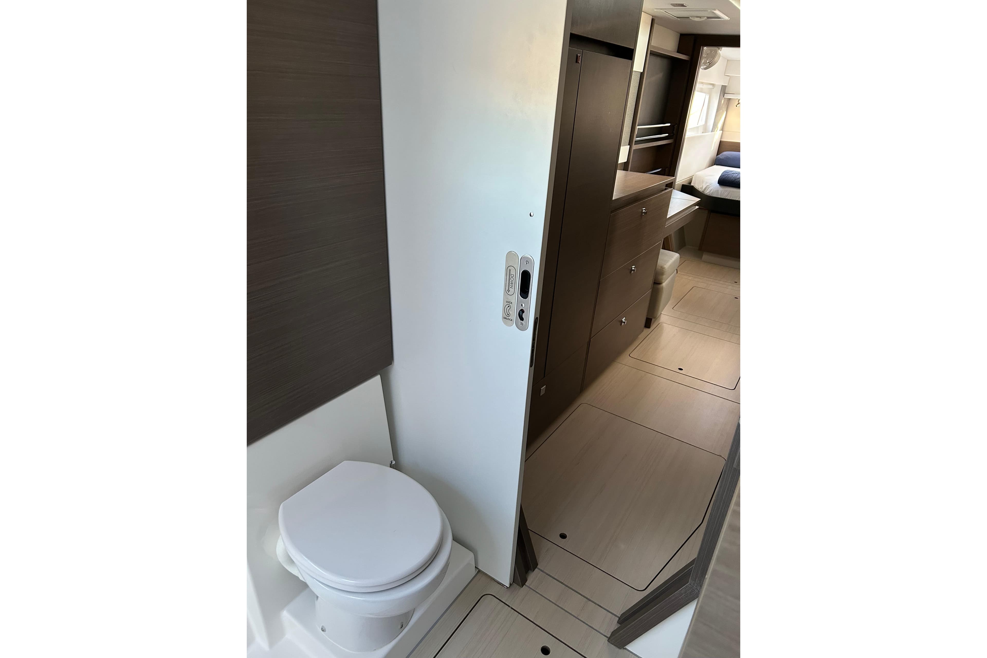 Modern interior of 2022 Leopard 42 yacht, featuring a compact bathroom and sleek cabinetry.