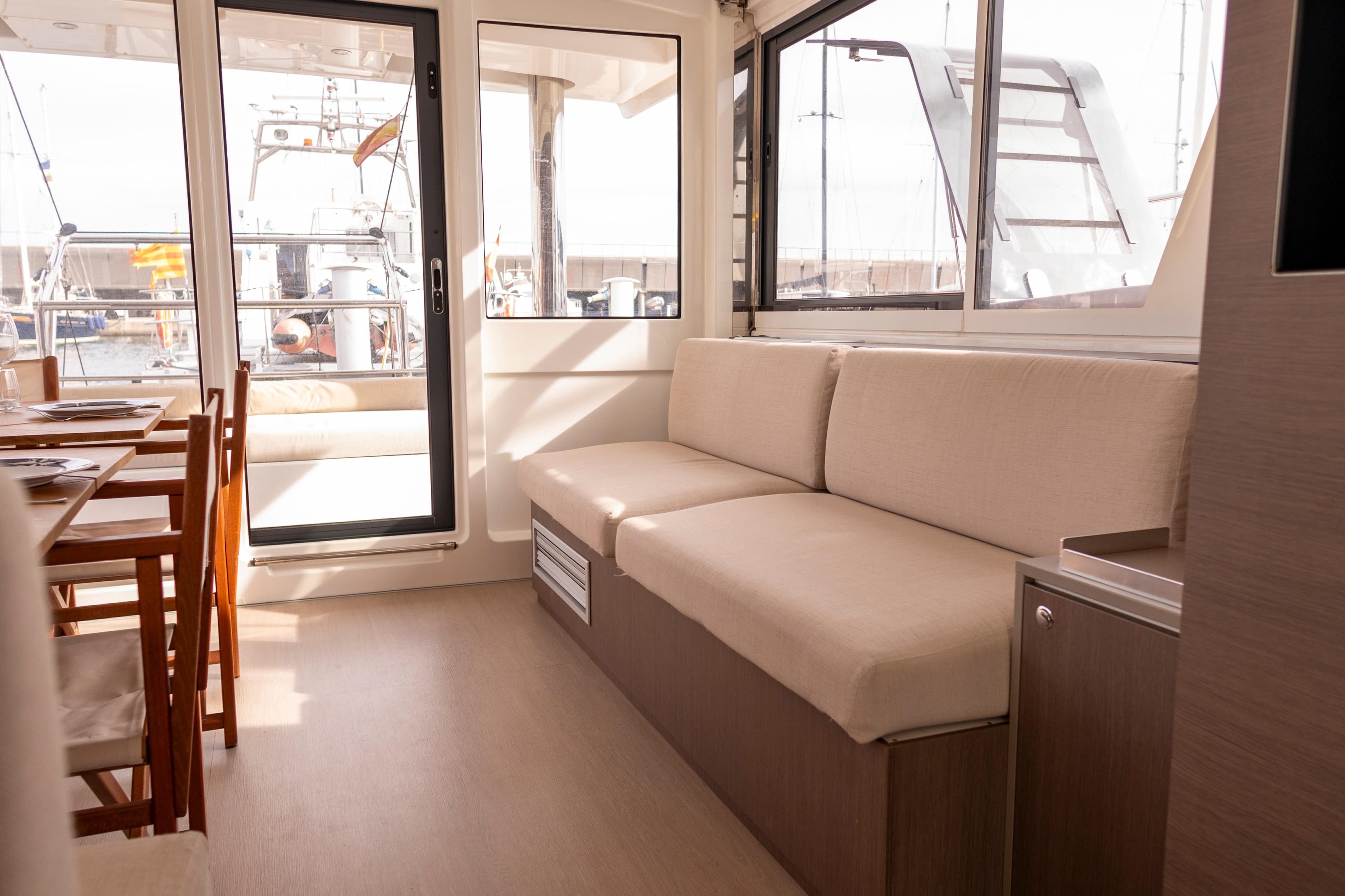 Interior of 2020 Bali 4.8 yacht with beige seating and dining area.