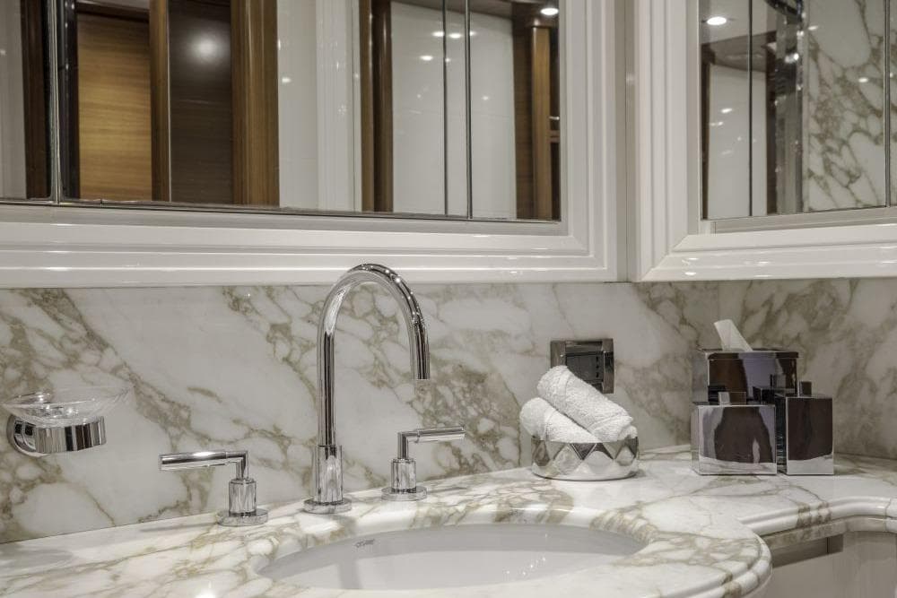 Luxurious marble bathroom sink with chrome fixtures on CRN 129 yacht, 2009 model.