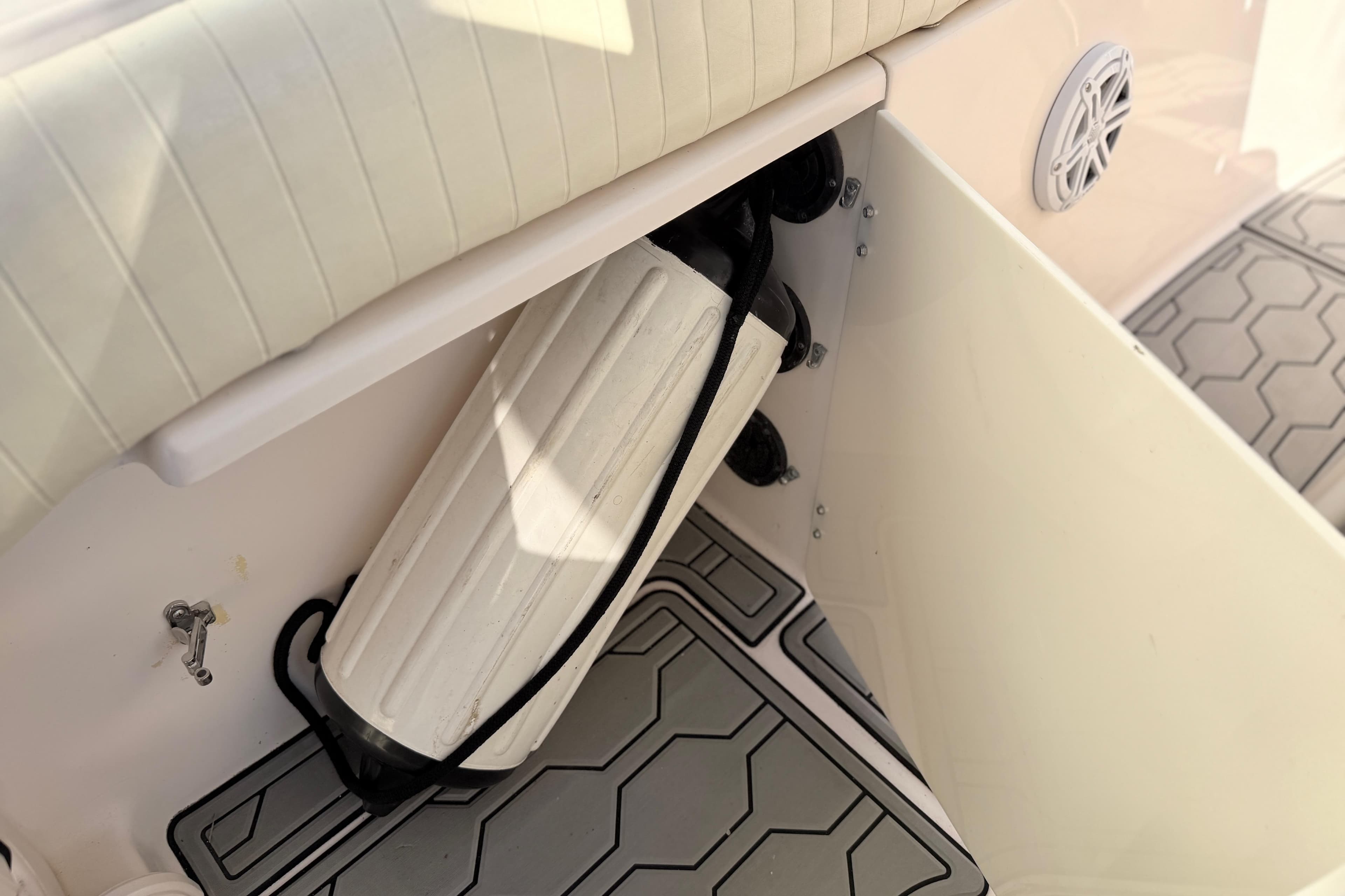 2004 Grady White 273 boat interior with fender storage and cushioned seating.