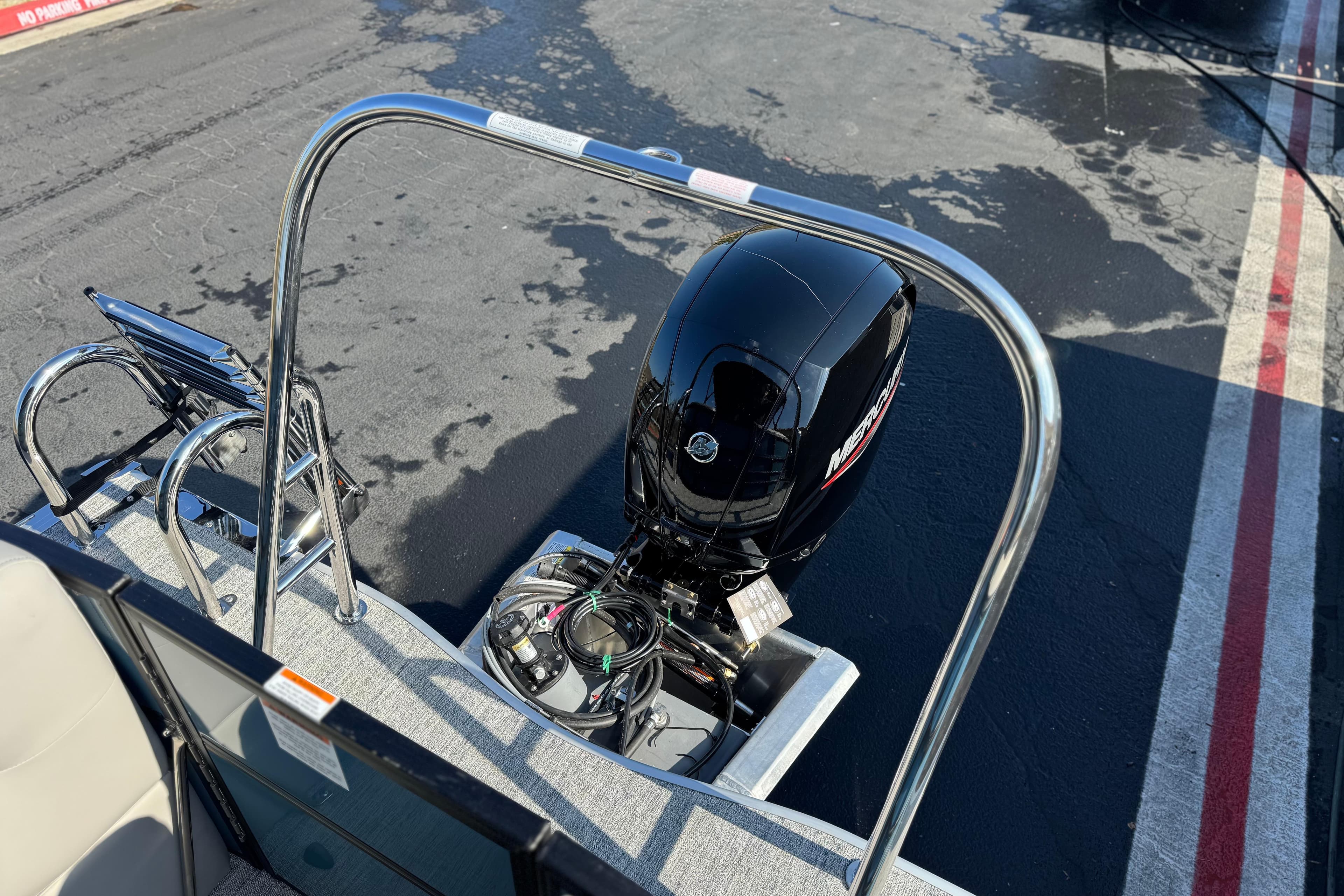 2026 Berkshire 22RFX LE boat with Mercury outboard motor, docked on wet pavement.